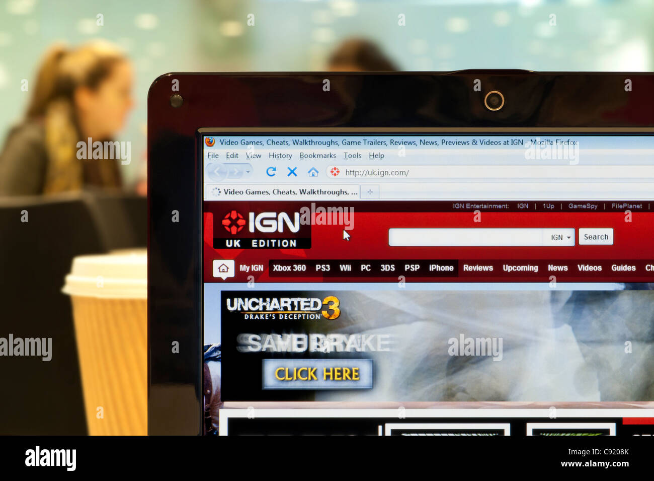 The IGN website shot in a coffee shop environment (Editorial use only: print, TV, e-book and editorial website). Stock Photo