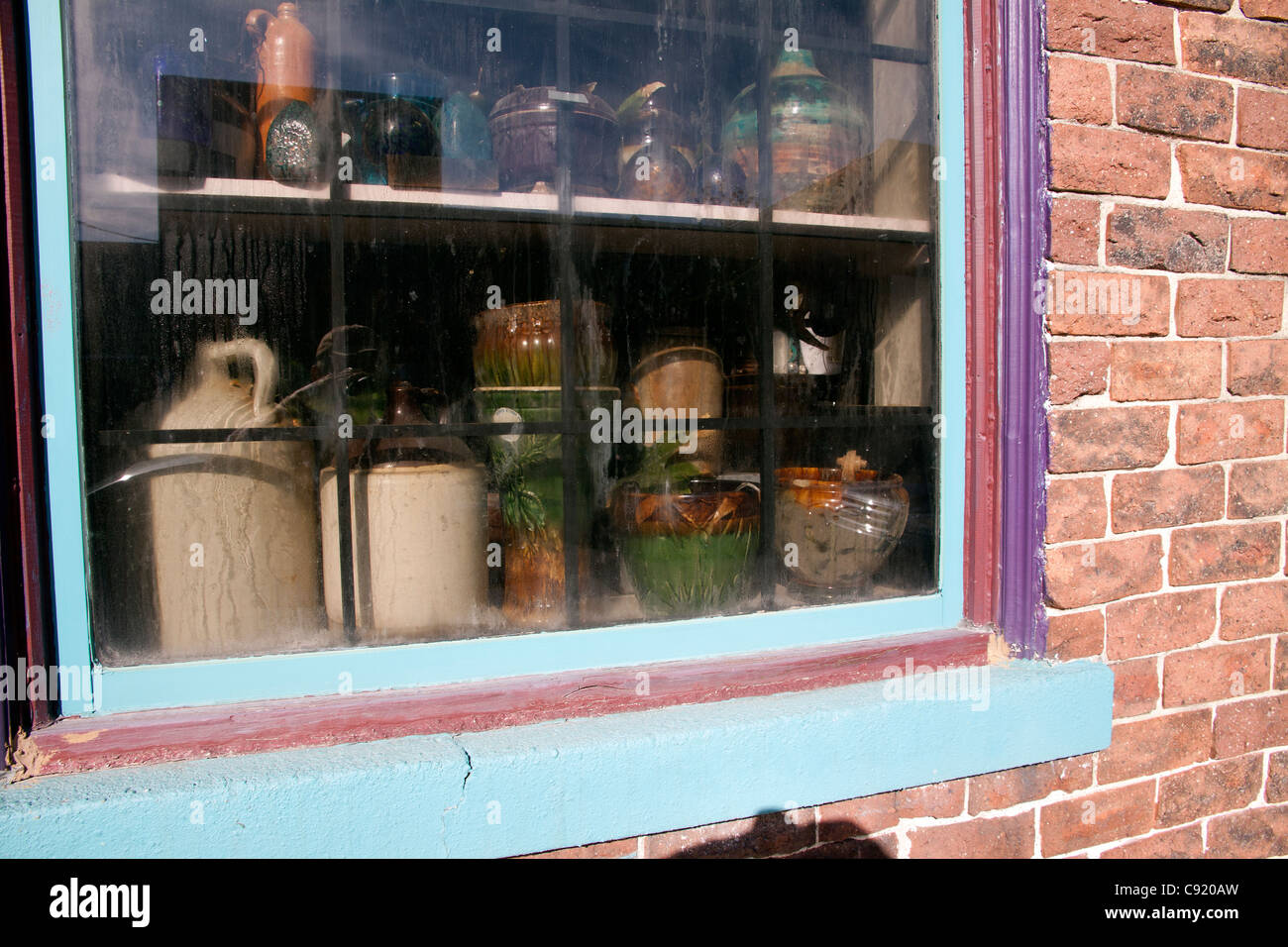 Crock Pots and Jugs in window of antique shop Indiana USA Stock Photo