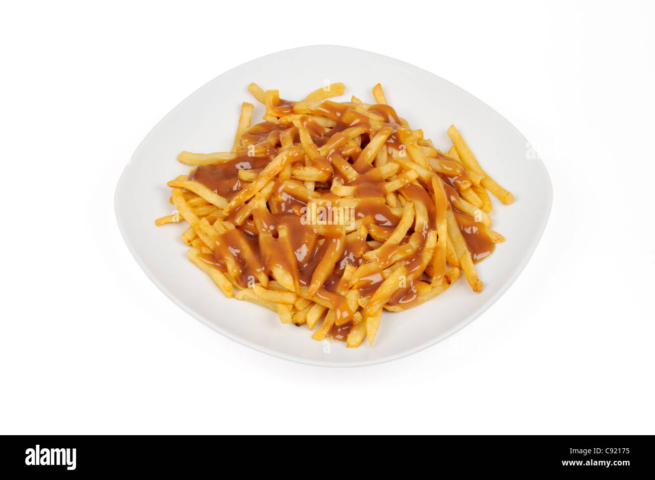 Chips and gravy on white plate on white background cut out. Stock Photo