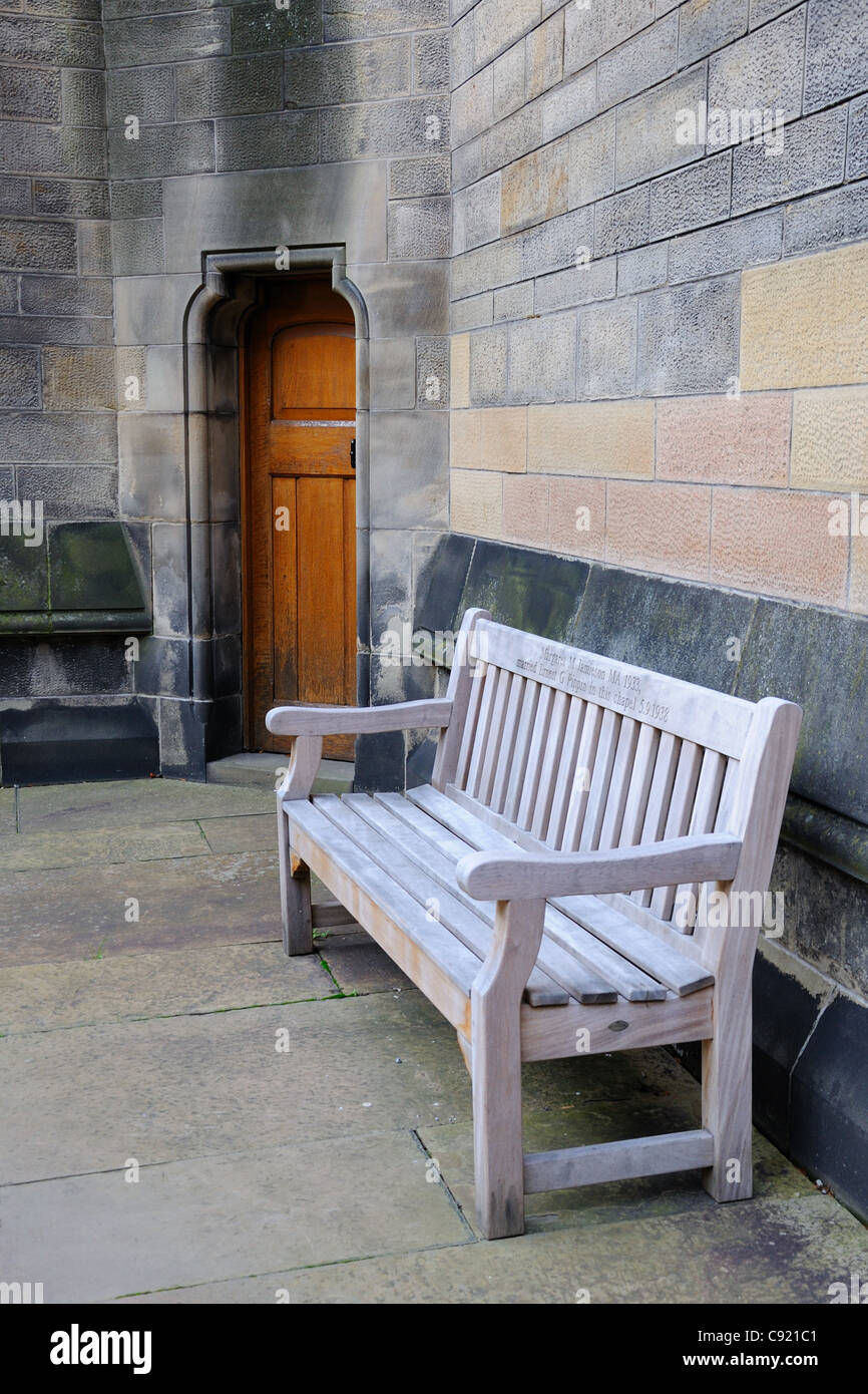Dedicated wooden bench sits outside the chapel at the side of an old