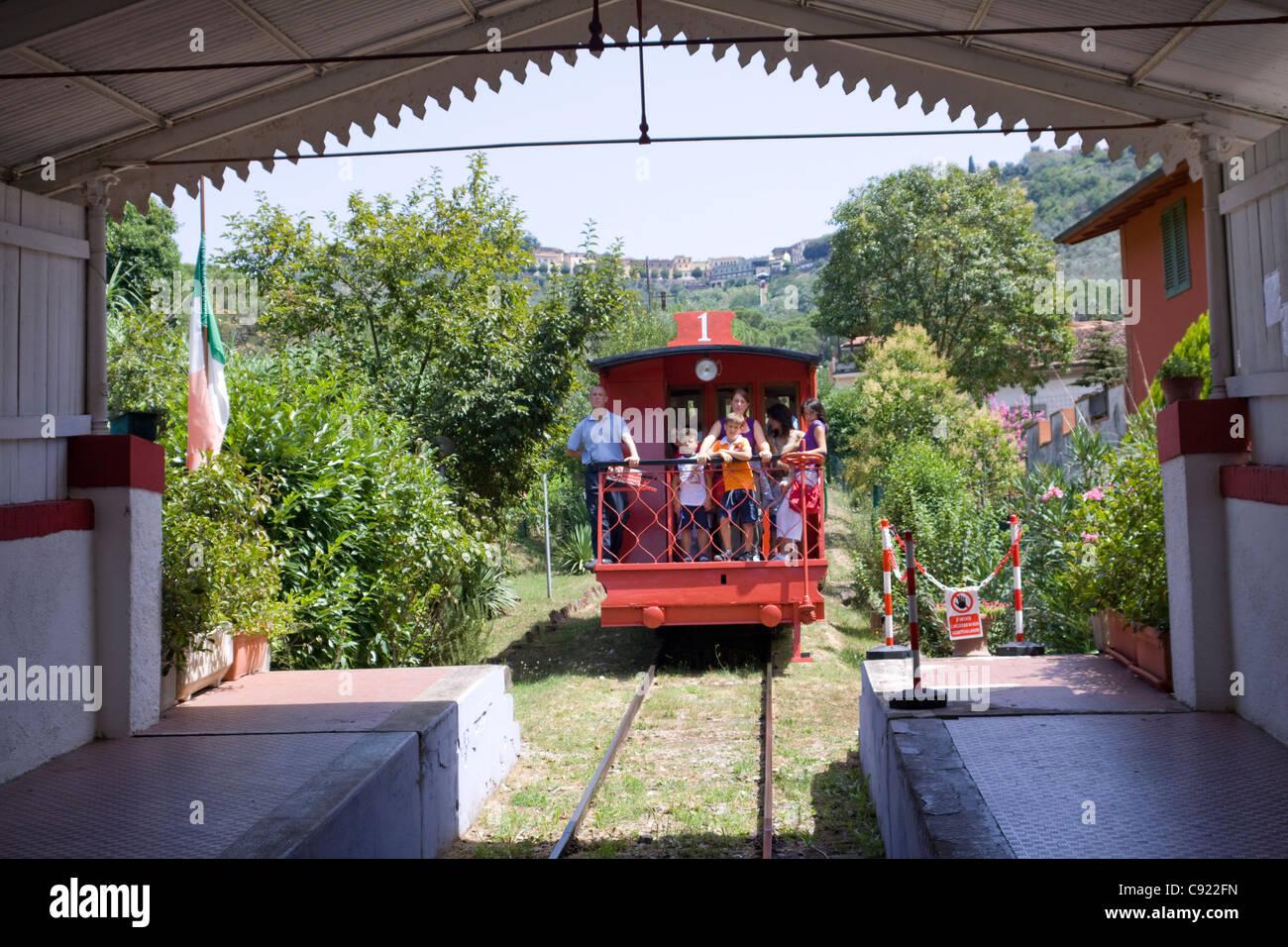 There is a funicular train carrying passengers arriving at the station at Montecatini Terme station. Stock Photo