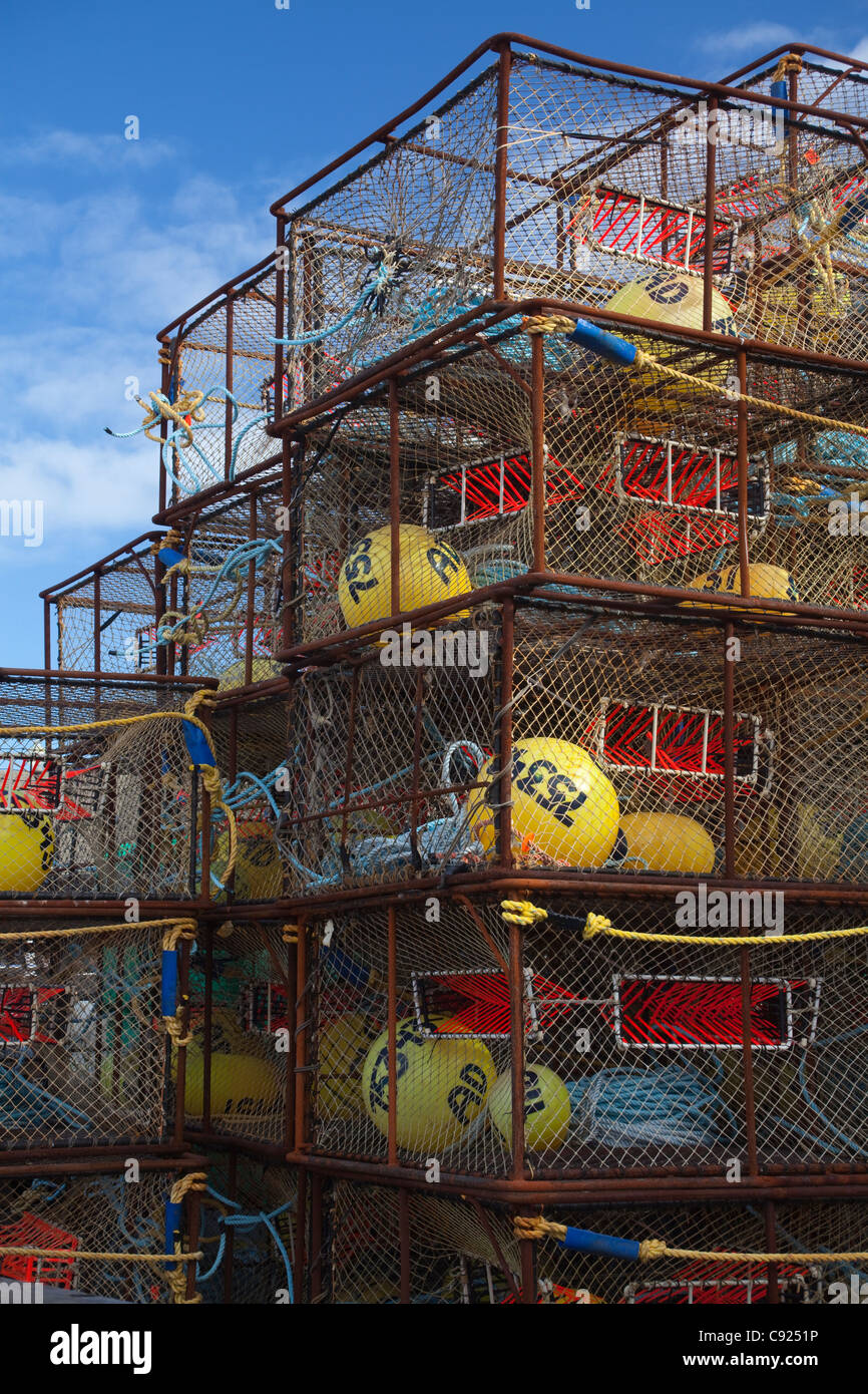 Stack of crab pots rigged with orange triggers for Pacific cod fishery and stored near Pier One in the City of Kodiak, Alaska Stock Photo