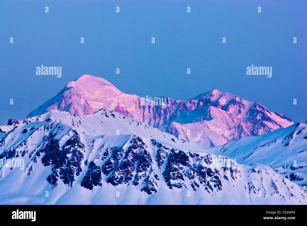 View of dawn alpenglow on the North and South summits of Mount McKinley as seen from the Denali State Park Viewpoint, Alaska Stock Photo