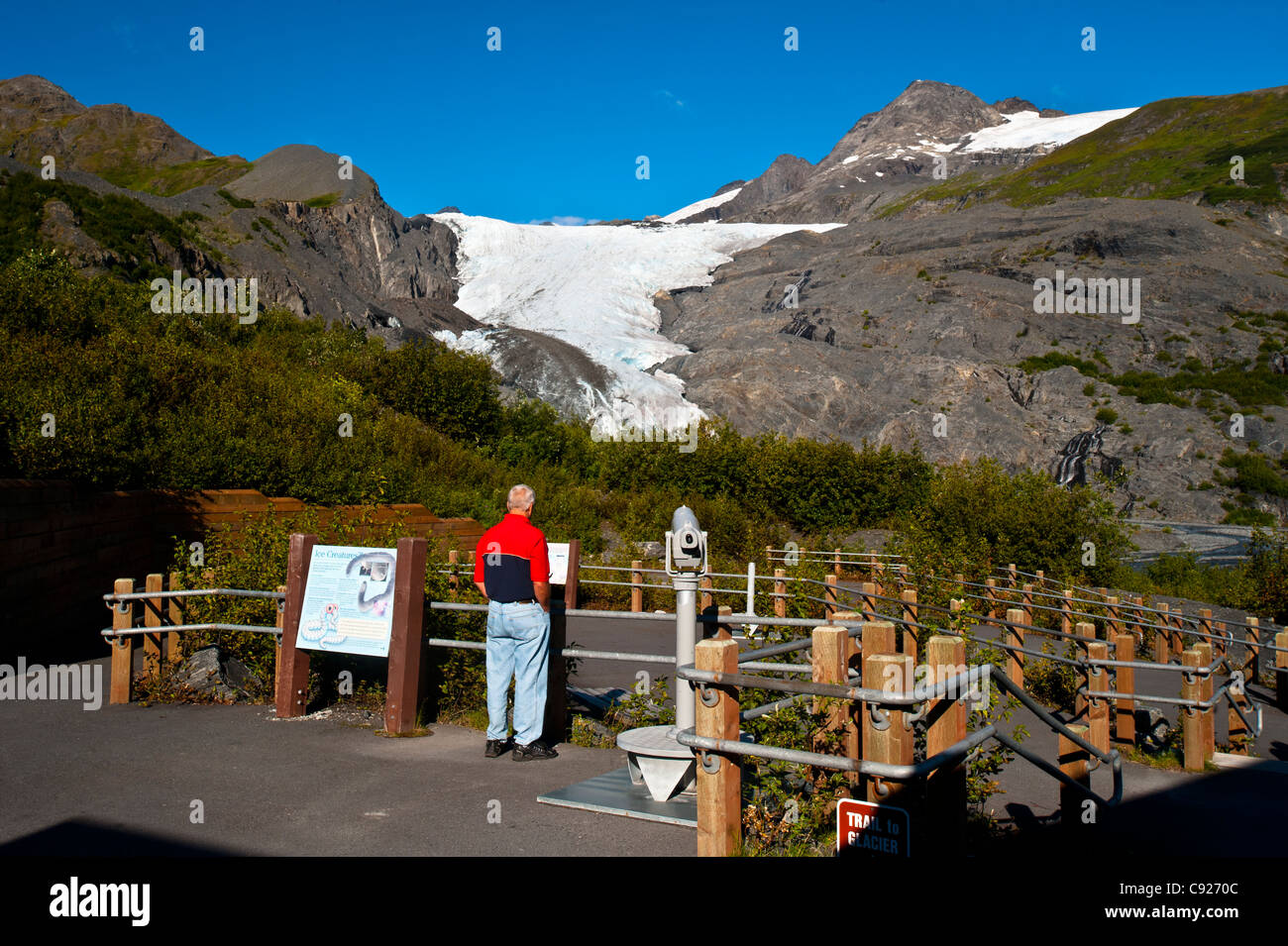 Person reading a sign on the Glacier Trail at Worthington Glacier State Recreation Area, Chugach National Forest, Alaska Stock Photo