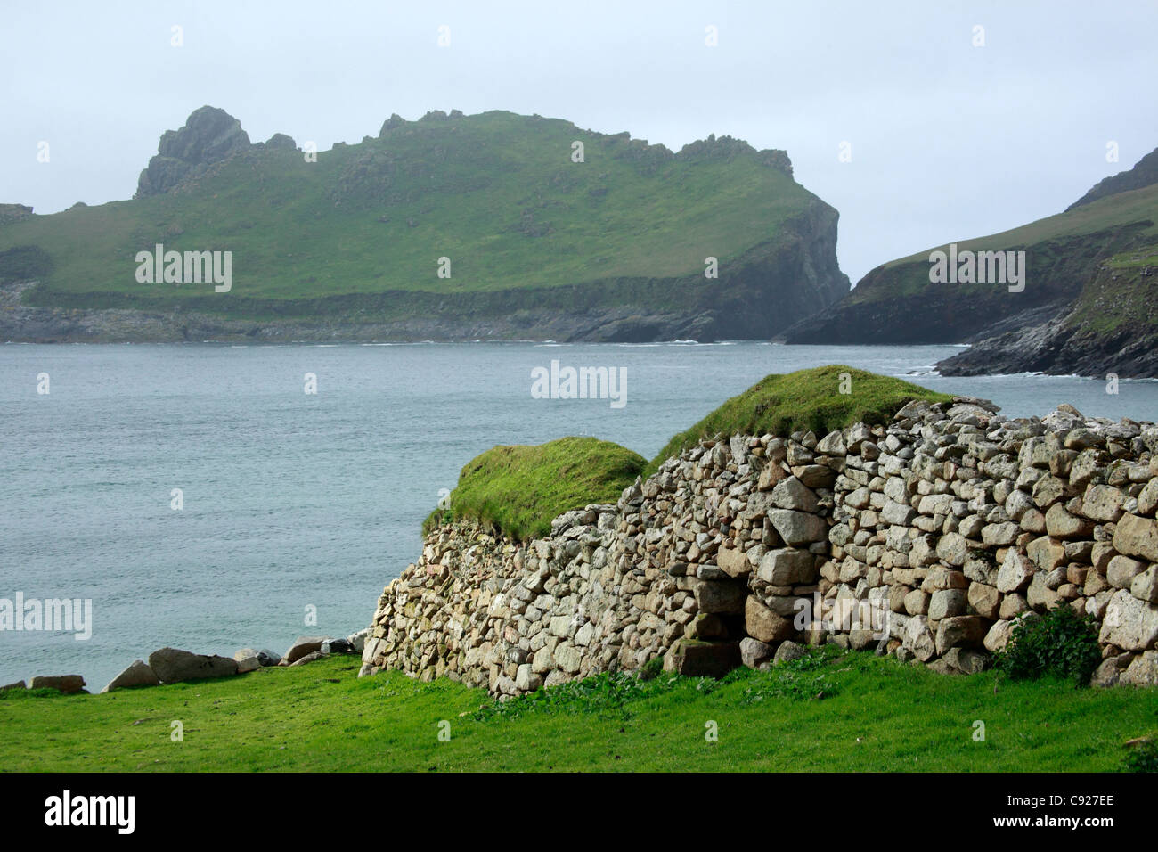 Grasscovered buildings overlooking the bay at St Kilda in the Outer