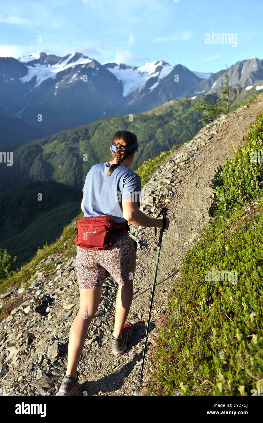 Woman hikes the steep North Face Trail at Alyeska Resort in Girdwood, Southcentral Alaska, Summer Stock Photo