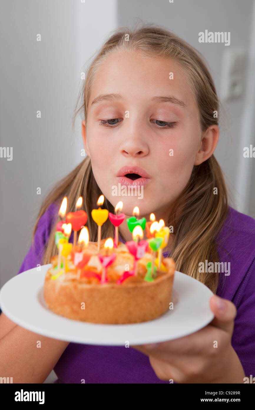 Girl blowing out birthday candles Stock Photo Alamy