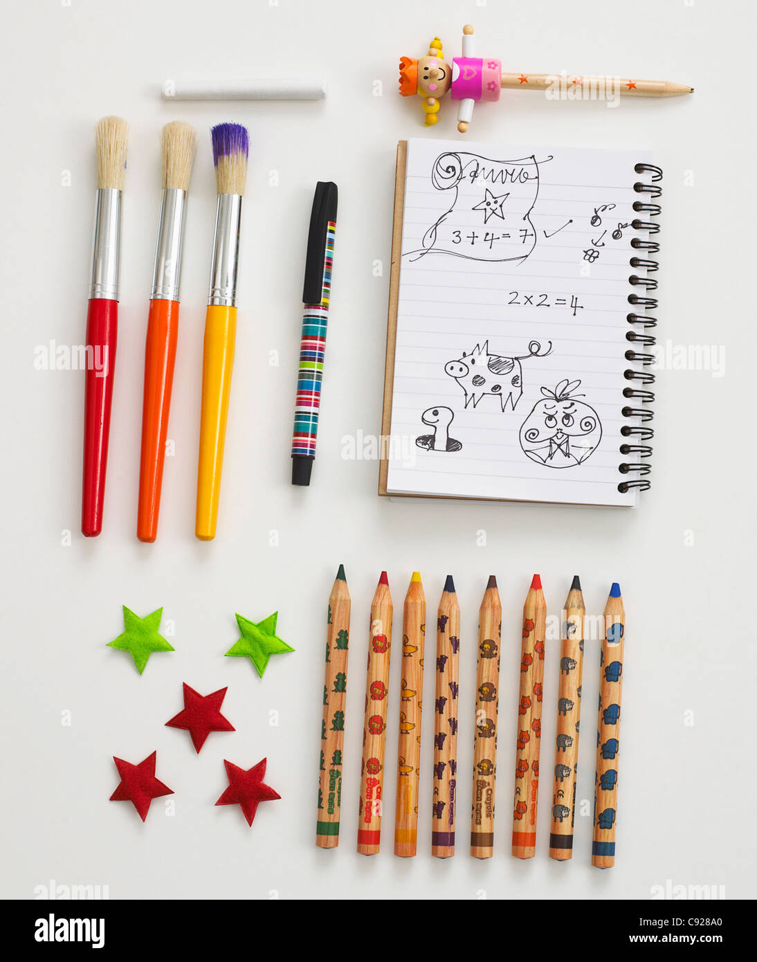 Assorted stationary including paintbrushes, pencils and notepad Stock Photo