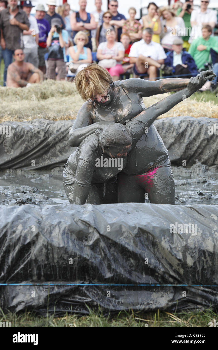 The quirky annual Mud Wrestling Championships, held at The Lowland Games festival, end of July in Thorney, Somerset, England Stock Photo