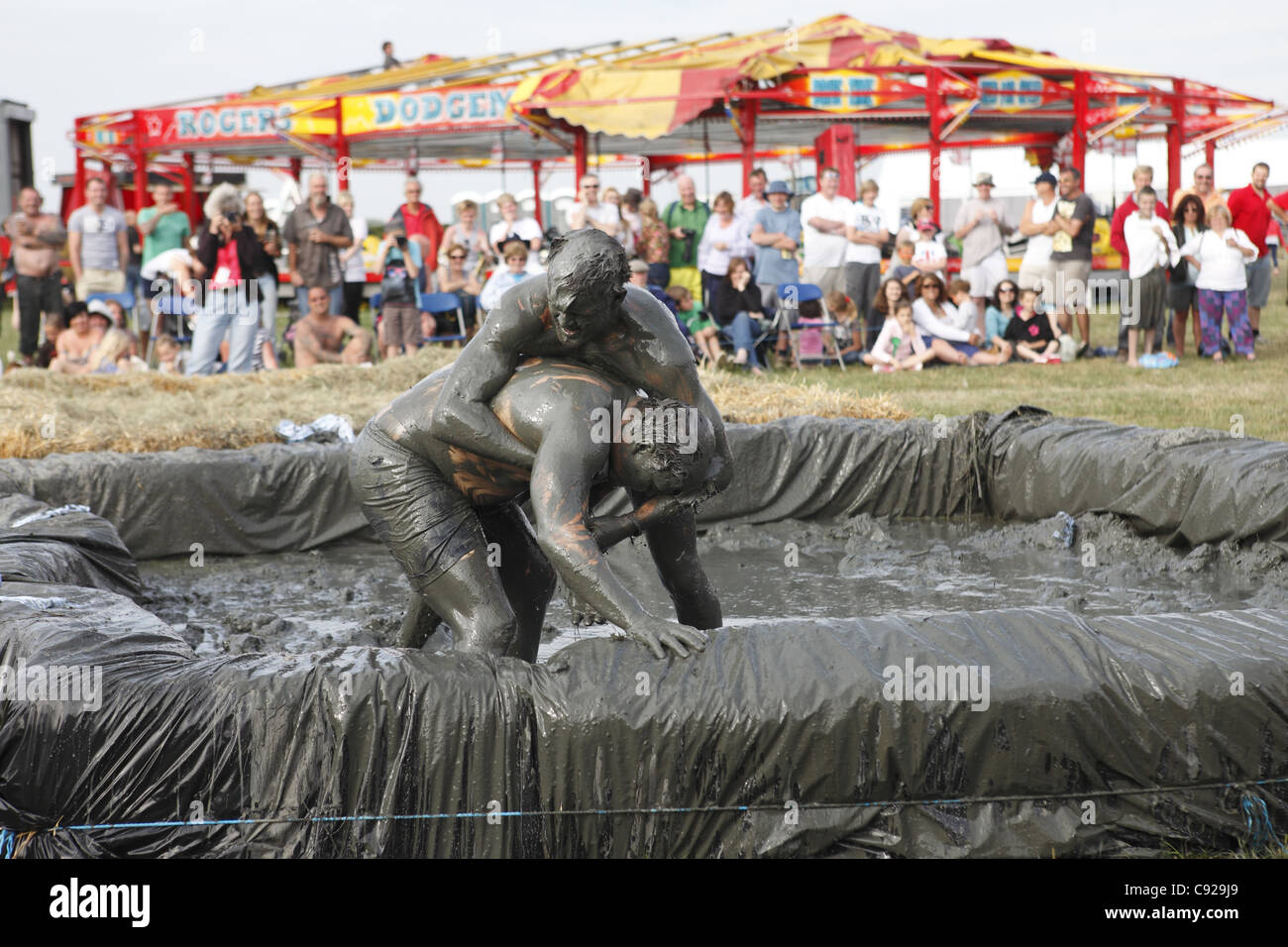The quirky annual Mud Wrestling Championships, held at The Lowland Games festival, end of July in Thorney, Somerset, England Stock Photo