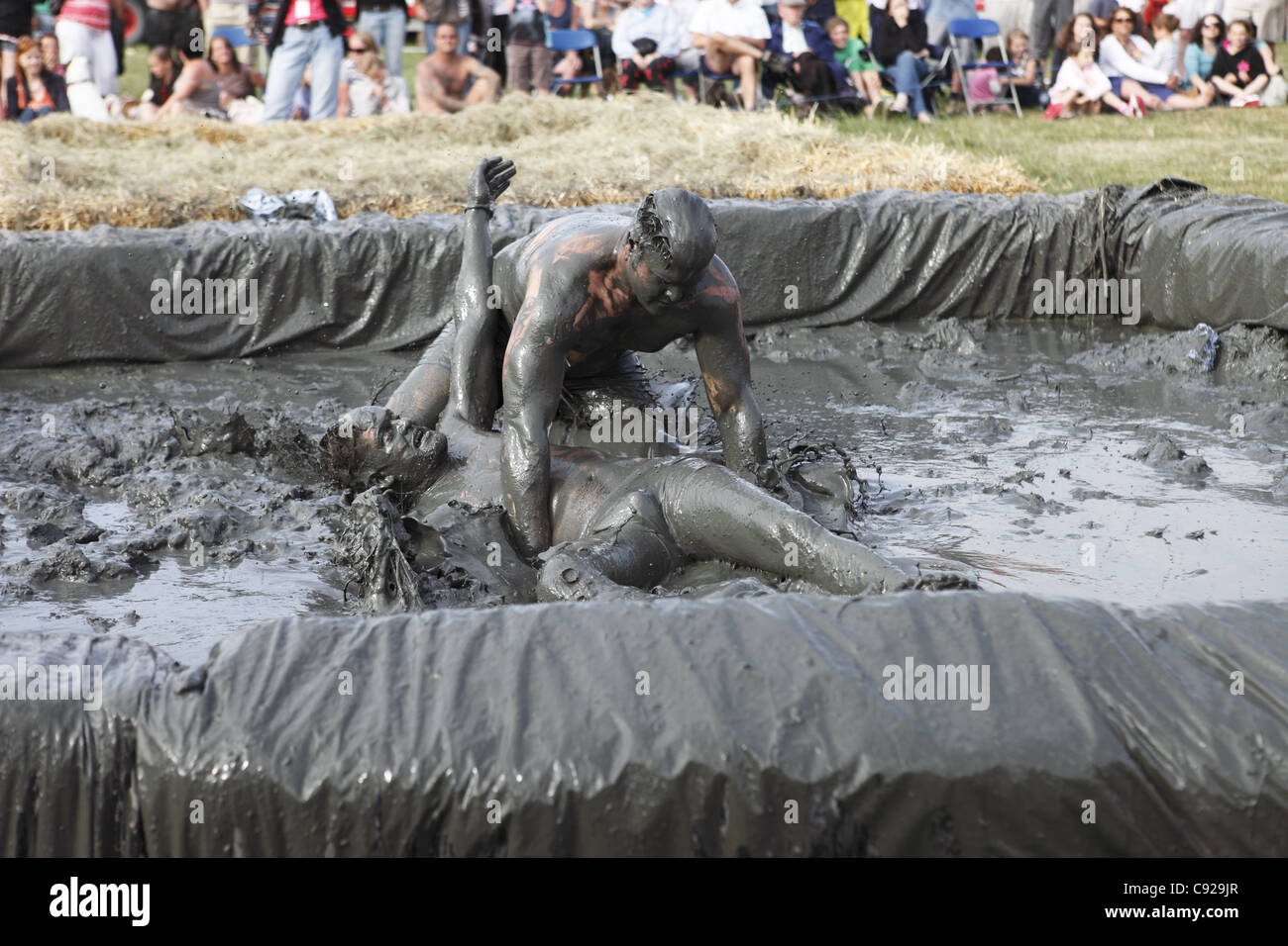 The quirky annual Mud Wrestling Championships, held at The Lowland Games festival, end of July in Thorney, Somerset, England Stock Photo