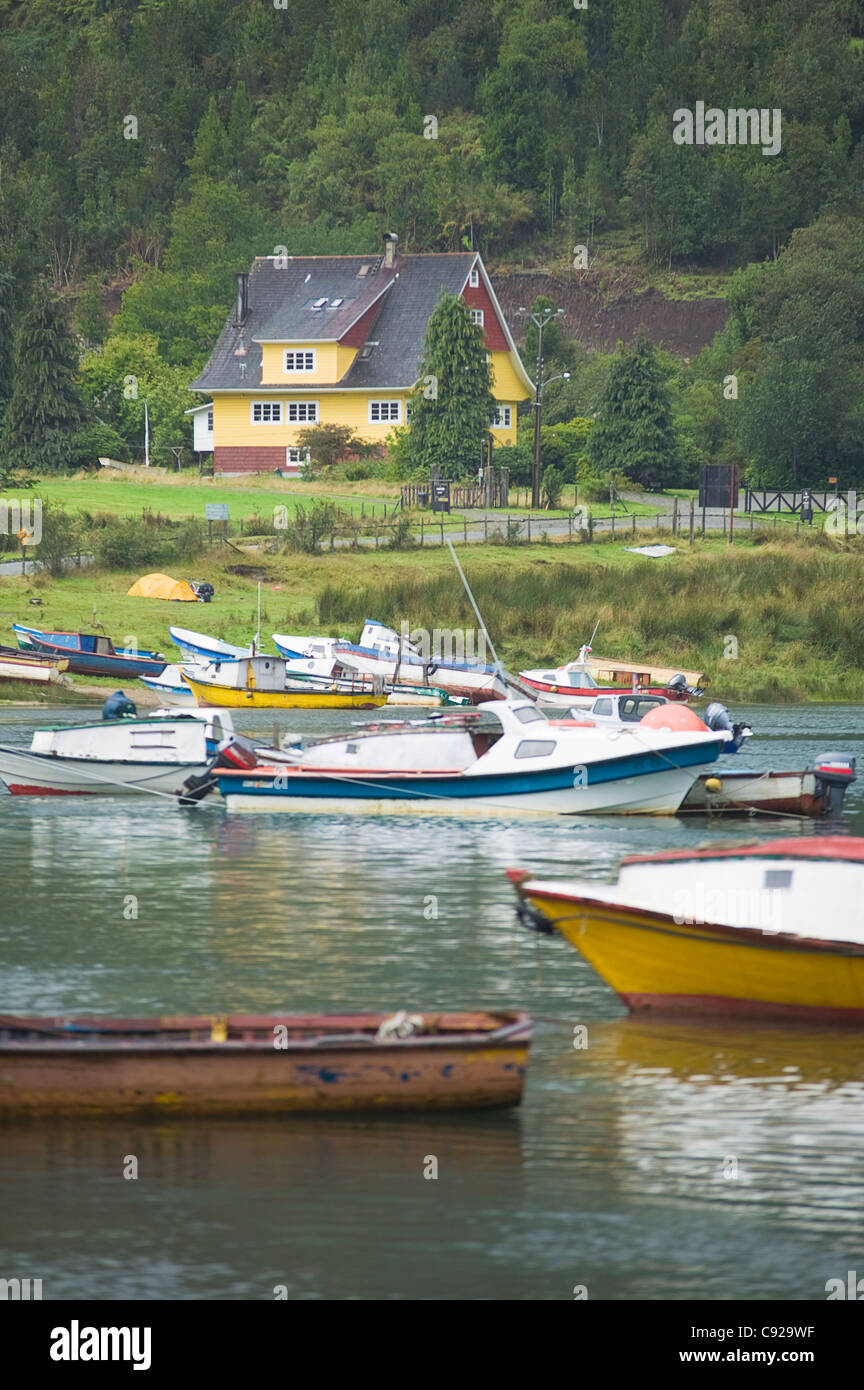 Chile, Patagonia, Puerto Puyuhuapi, view of boats on the lake with Casa Ludwig in the background Stock Photo