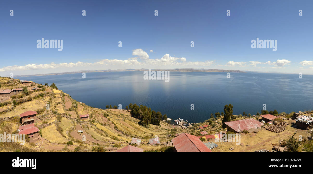 housing poor view lake titicaca house roof sky poverty basic blue cloud highest navigable taquile island puno horizon bright day Stock Photo