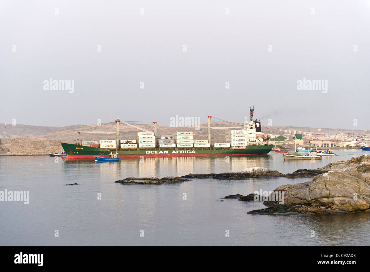 Container ship leaves the harbor of Luederitz in Namibia Stock Photo