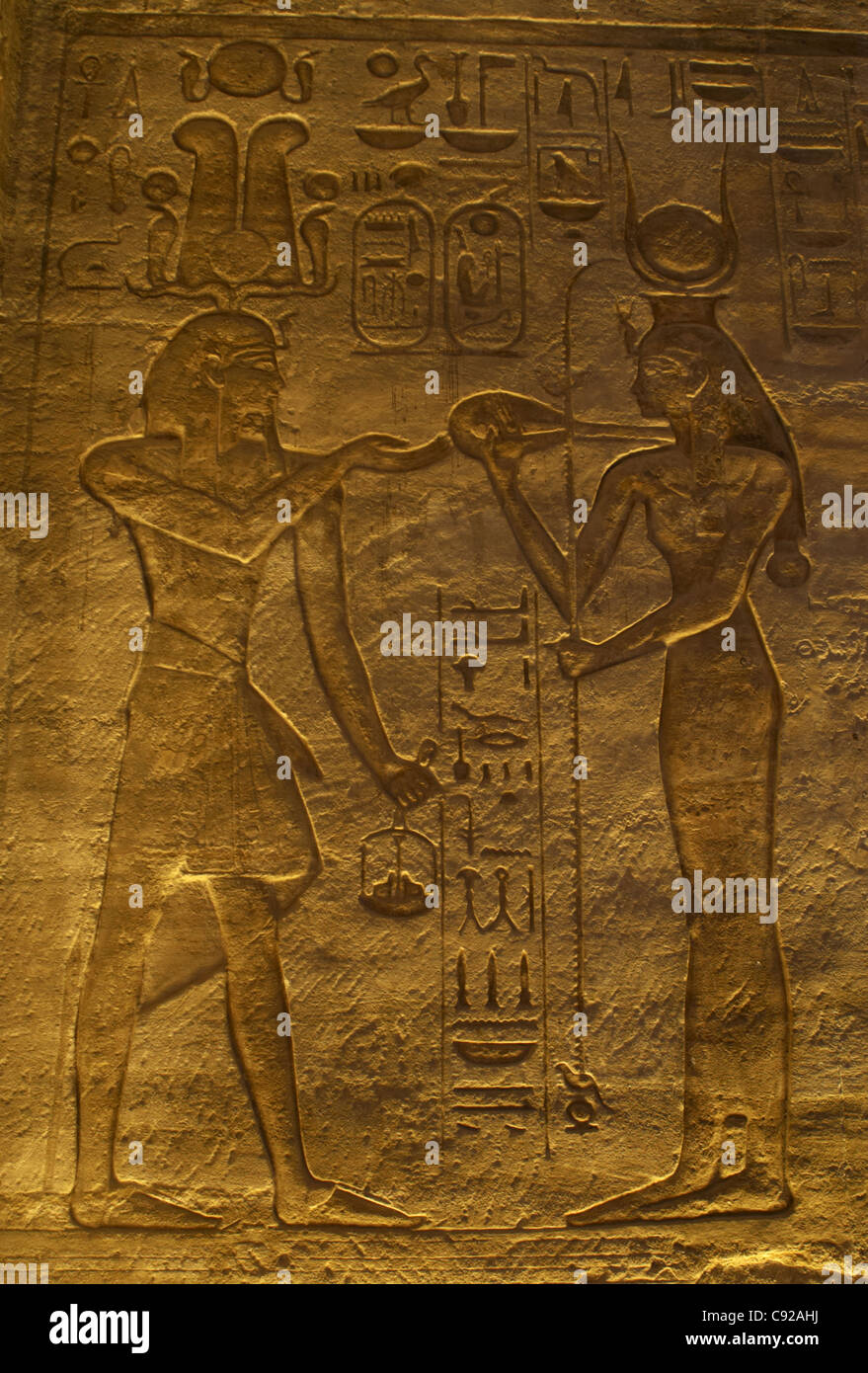 Egyptian art. Great Temple of Ramses II. Pharaoh Ramses II before a goddess. 19th Dynasty. New Kingdom. Abu Simbel. Egypt. Stock Photo