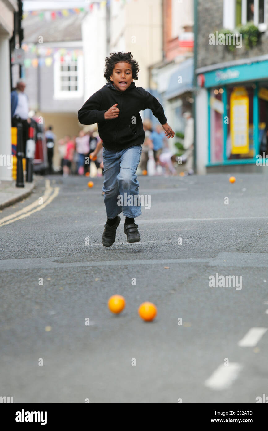 The quirky annual Totnes Orange Races, held on a Summer weekday morning on the High Street in Totnes, Devon, Englan Stock Photo