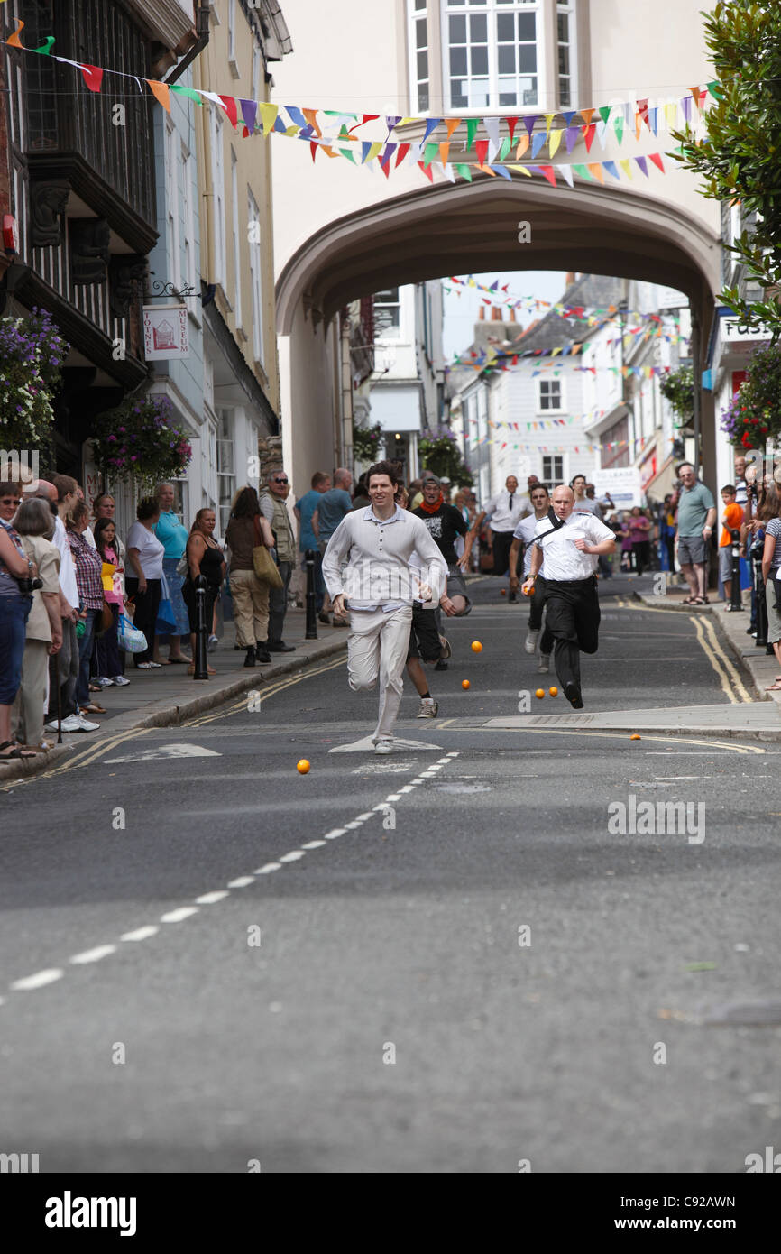 The quirky annual Totnes Orange Races, held on a Summer weekday morning on the High Street in Totnes, Devon, England Stock Photo