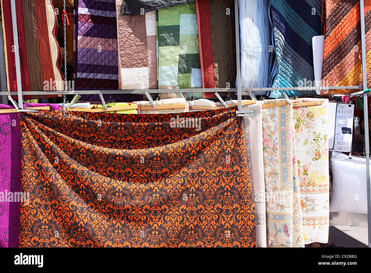 Spain, Alicante Province, Xabia, coloured quilts for sale at market stall Stock Photo