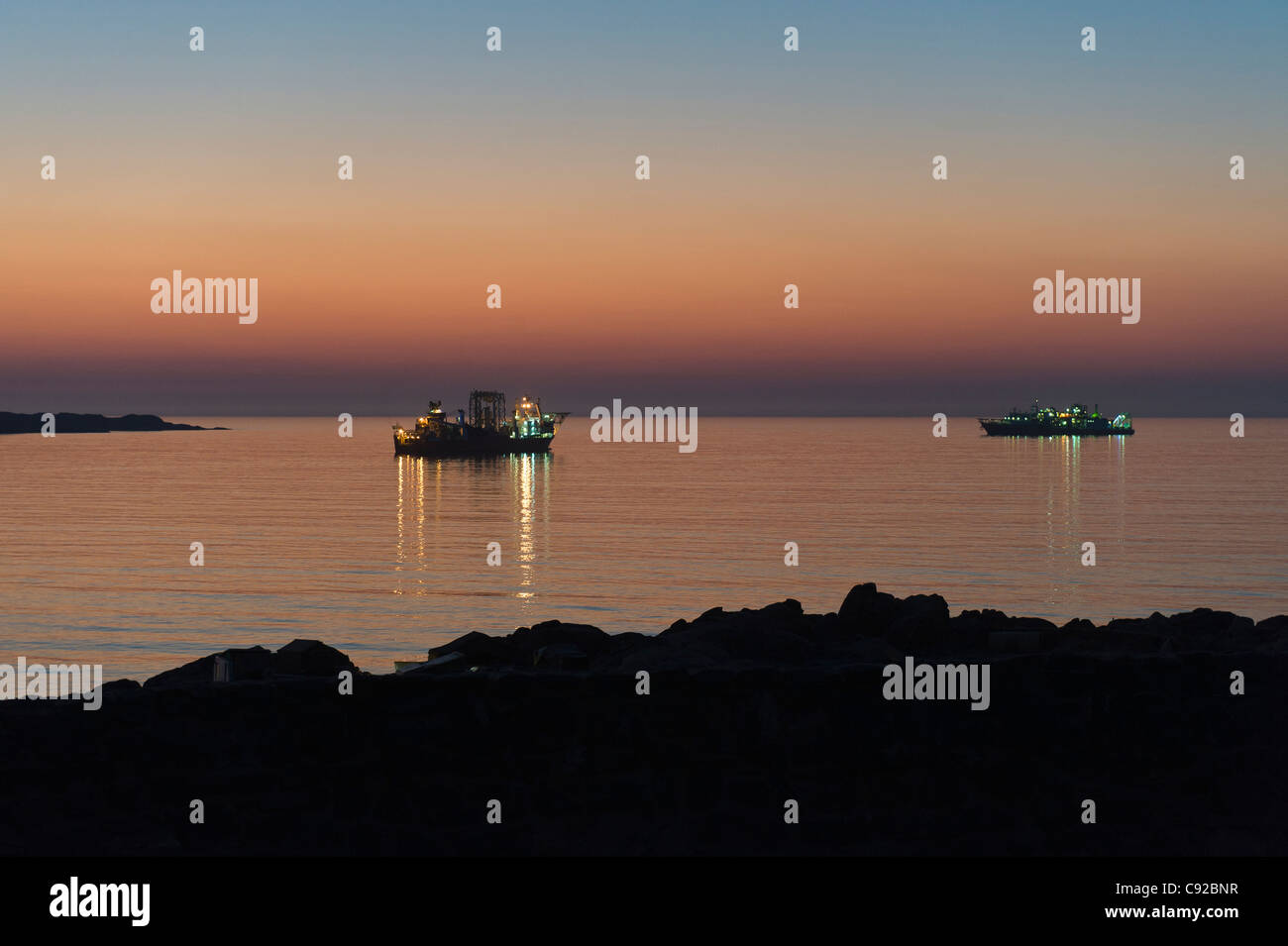 Two off-shore diamond mining ships anchored at sunset in the bay of Luederitz Namibia Stock Photo