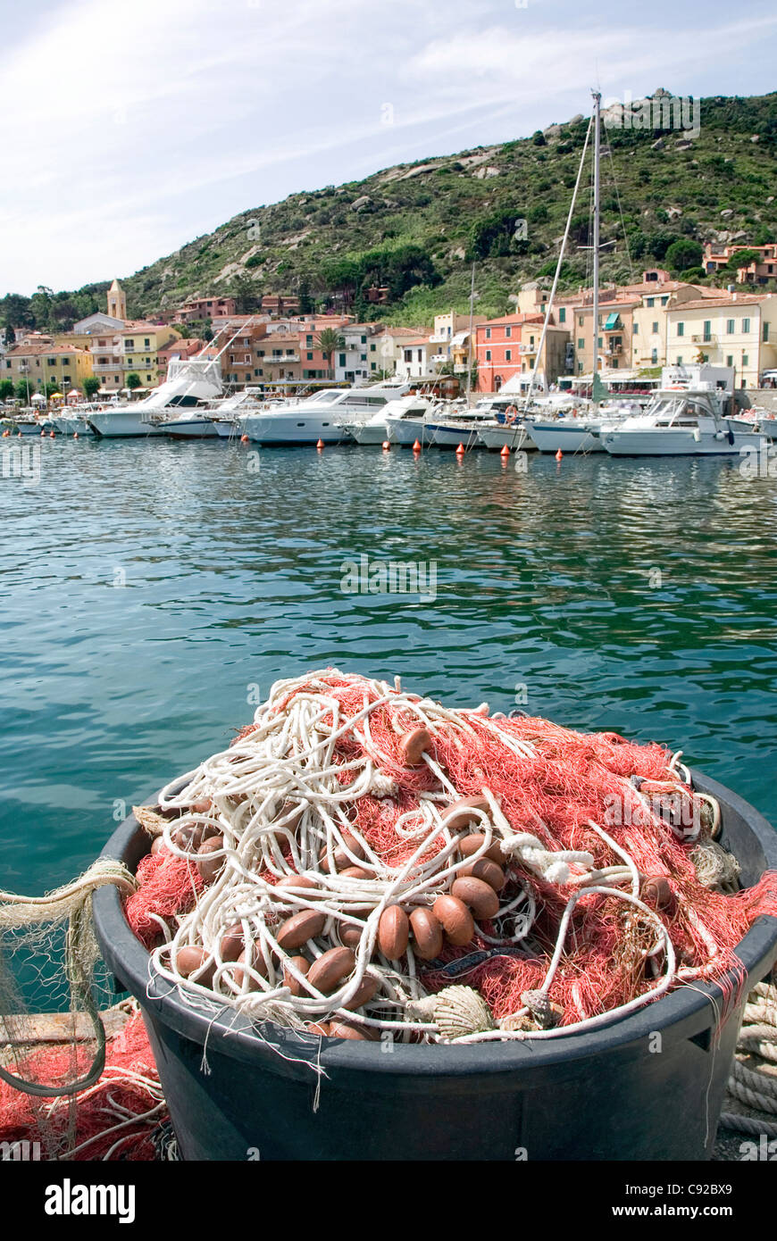 Italy, Tuscany, Isola del Giglio, fishing nets and coloured houses at Giglio Porto Stock Photo