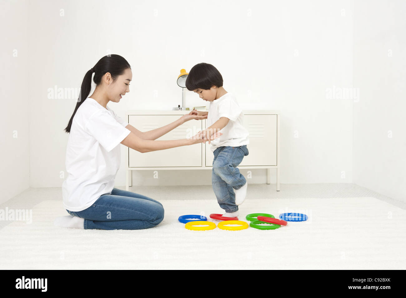 Mother playing with her son with stacking rings Stock Photo - Alamy