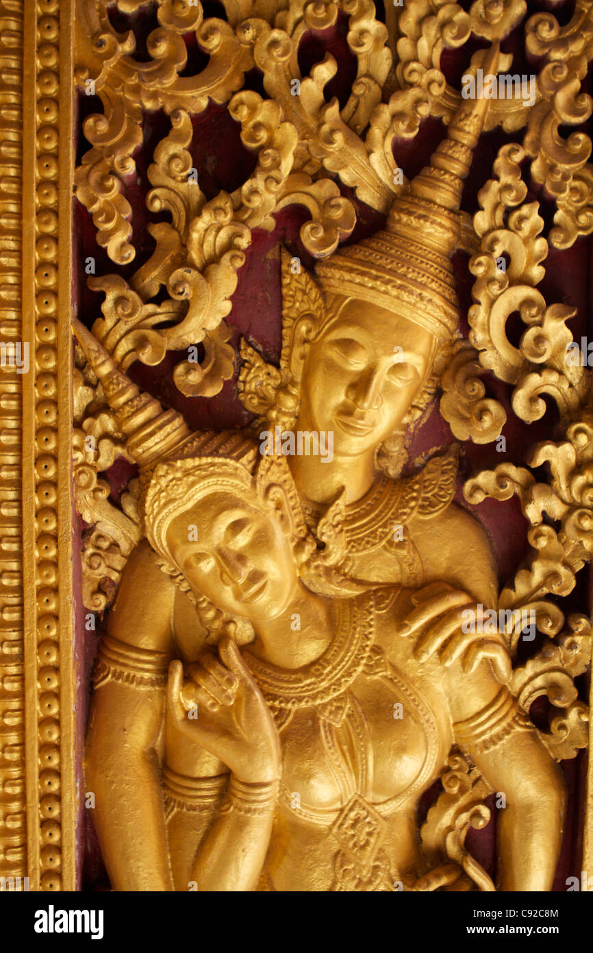 Gold relief of Khmer Apsara dancers inside the Funerary Carriage House of Wat Xieng Thong (built in 1560) in Luang Stock Photo