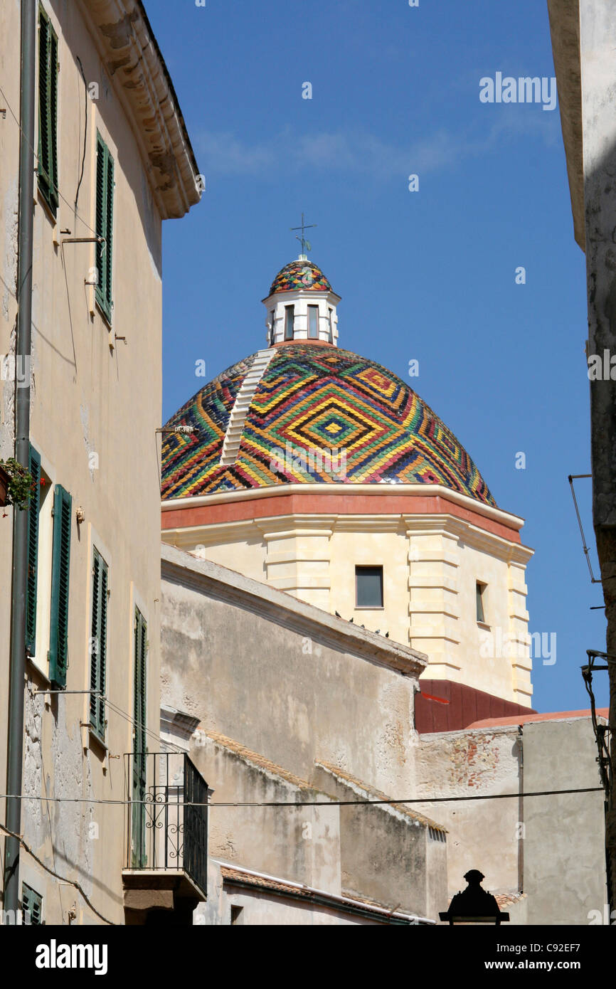 The multicoloured majolica-tiled cupola of San Michele with cross on the top in Via Calo Alberto with blue sky above Stock Photo