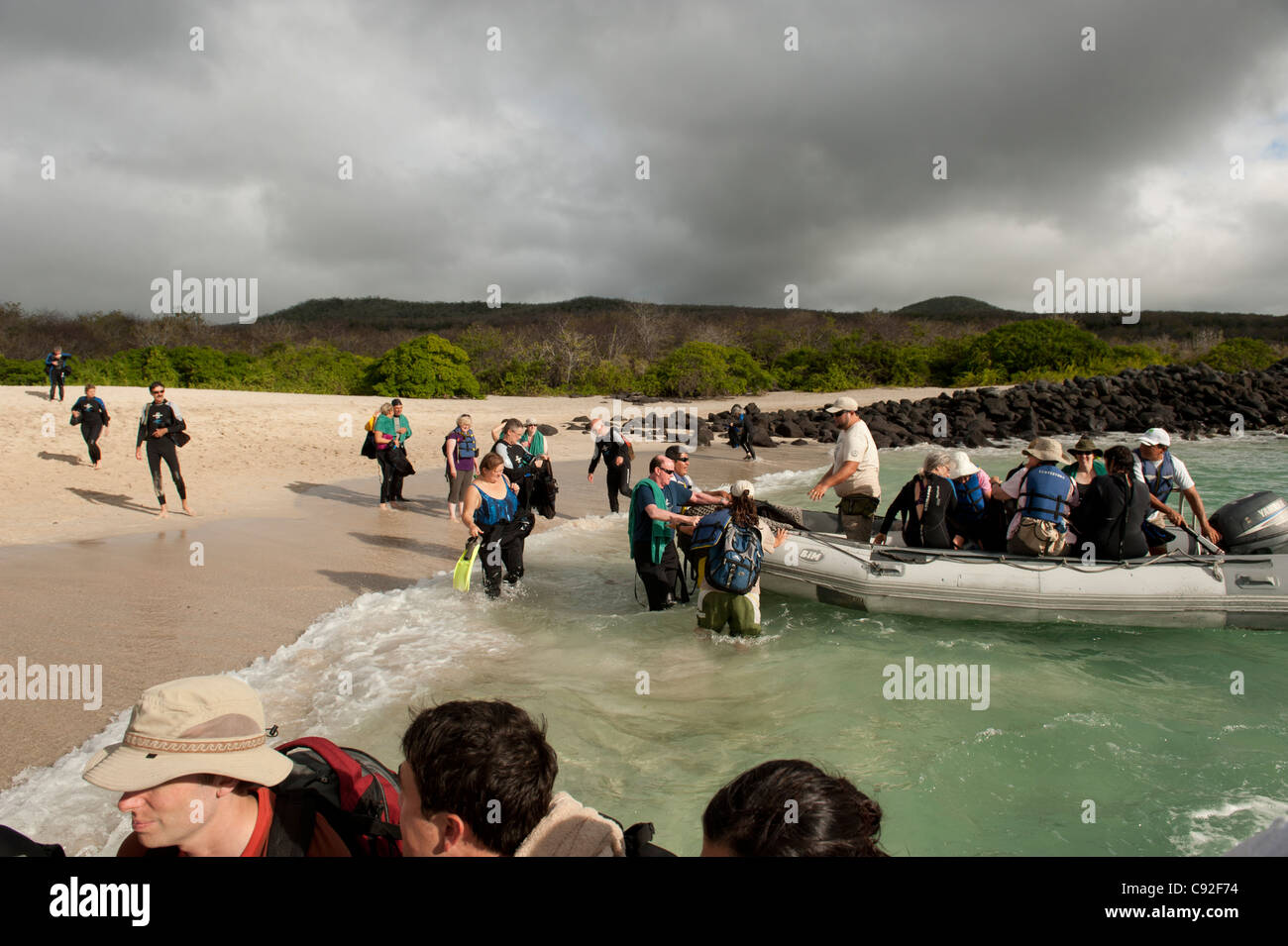 Tourists boarding into a panga, Playa Ochoa, San Cristobal Island