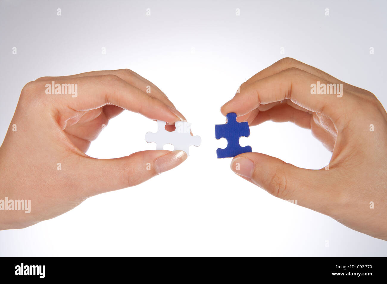 Two Puzzle Pieces Coming Together Stock Photo - Alamy