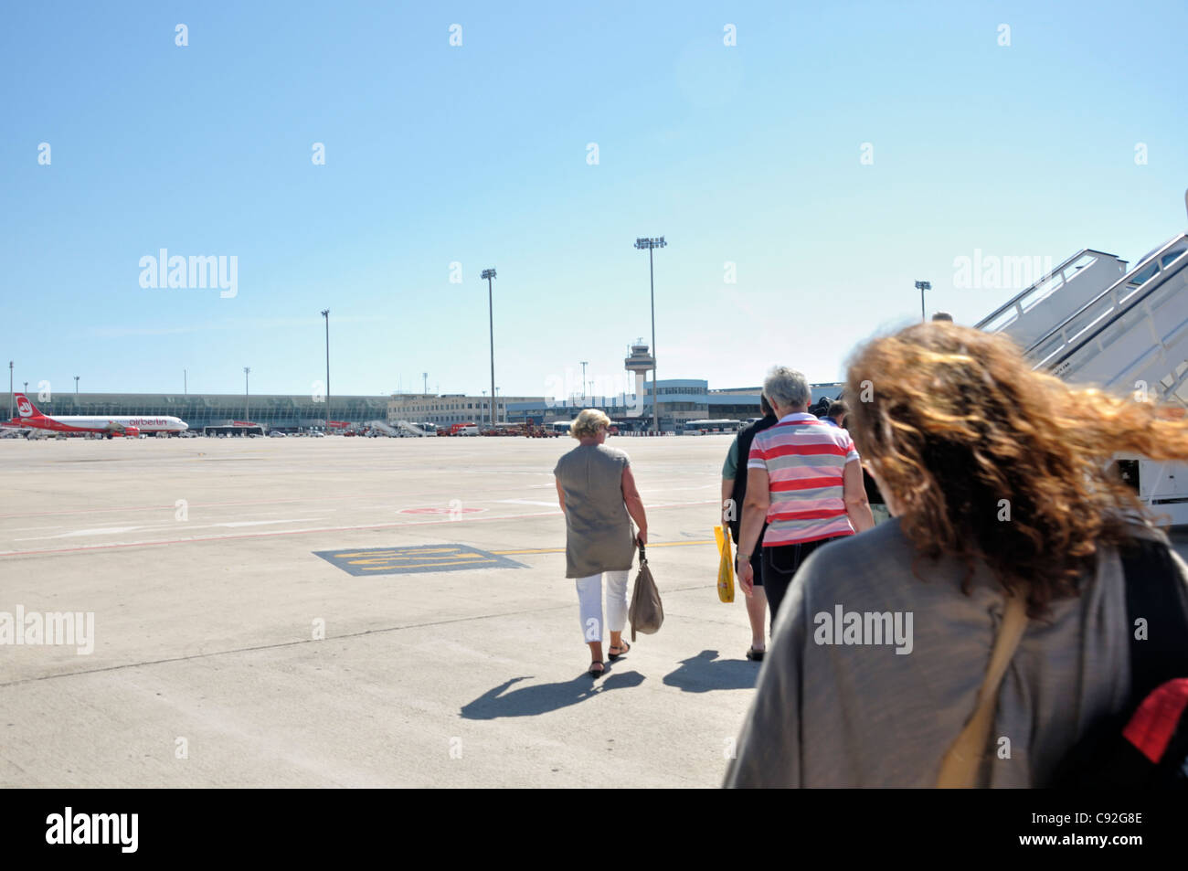Passengers boarding an airplane Stock Photo