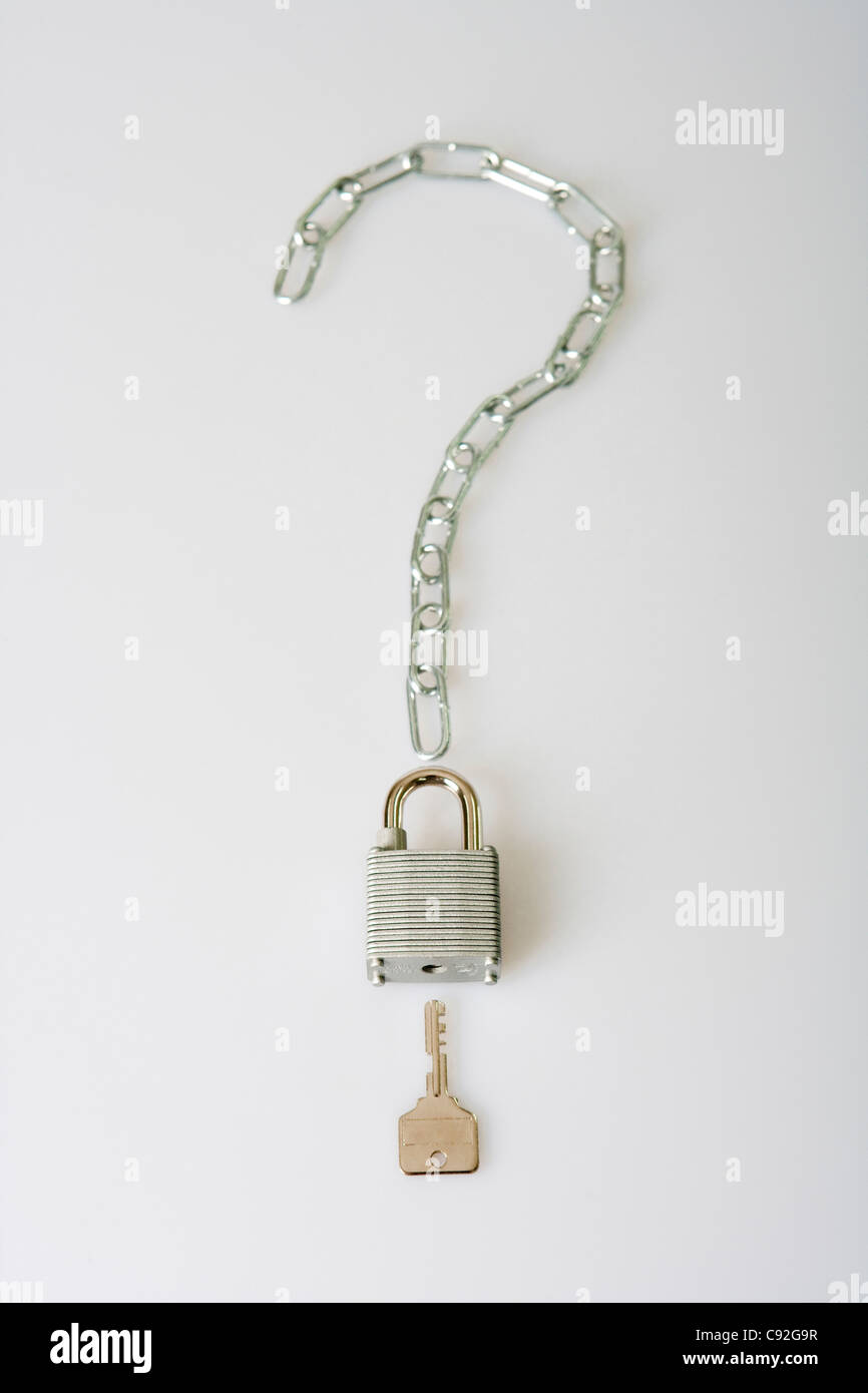 Chain in question mark sign with padlock and key below it Stock Photo