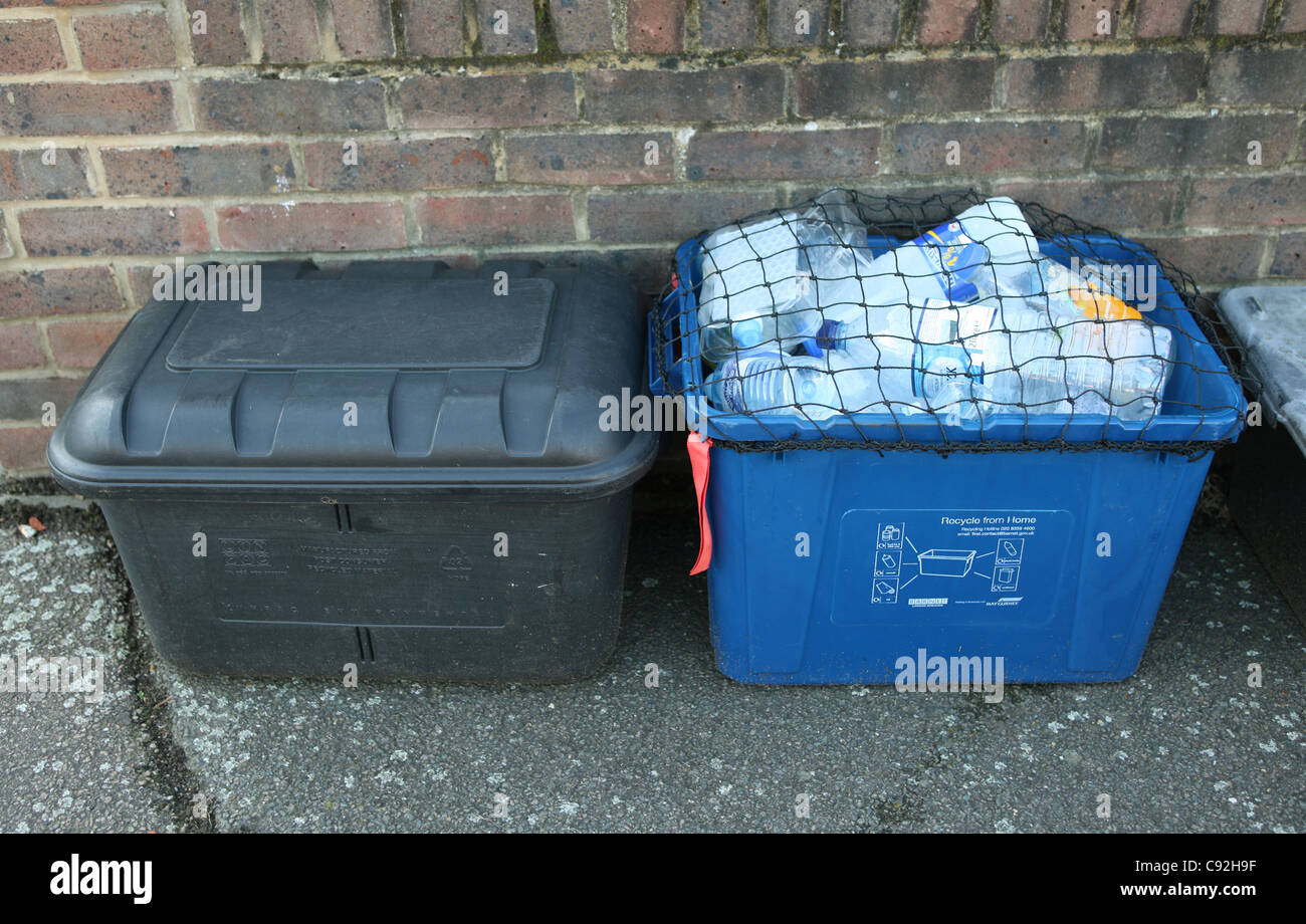Recycling bins on the pavement outside a house waiting to be collected
