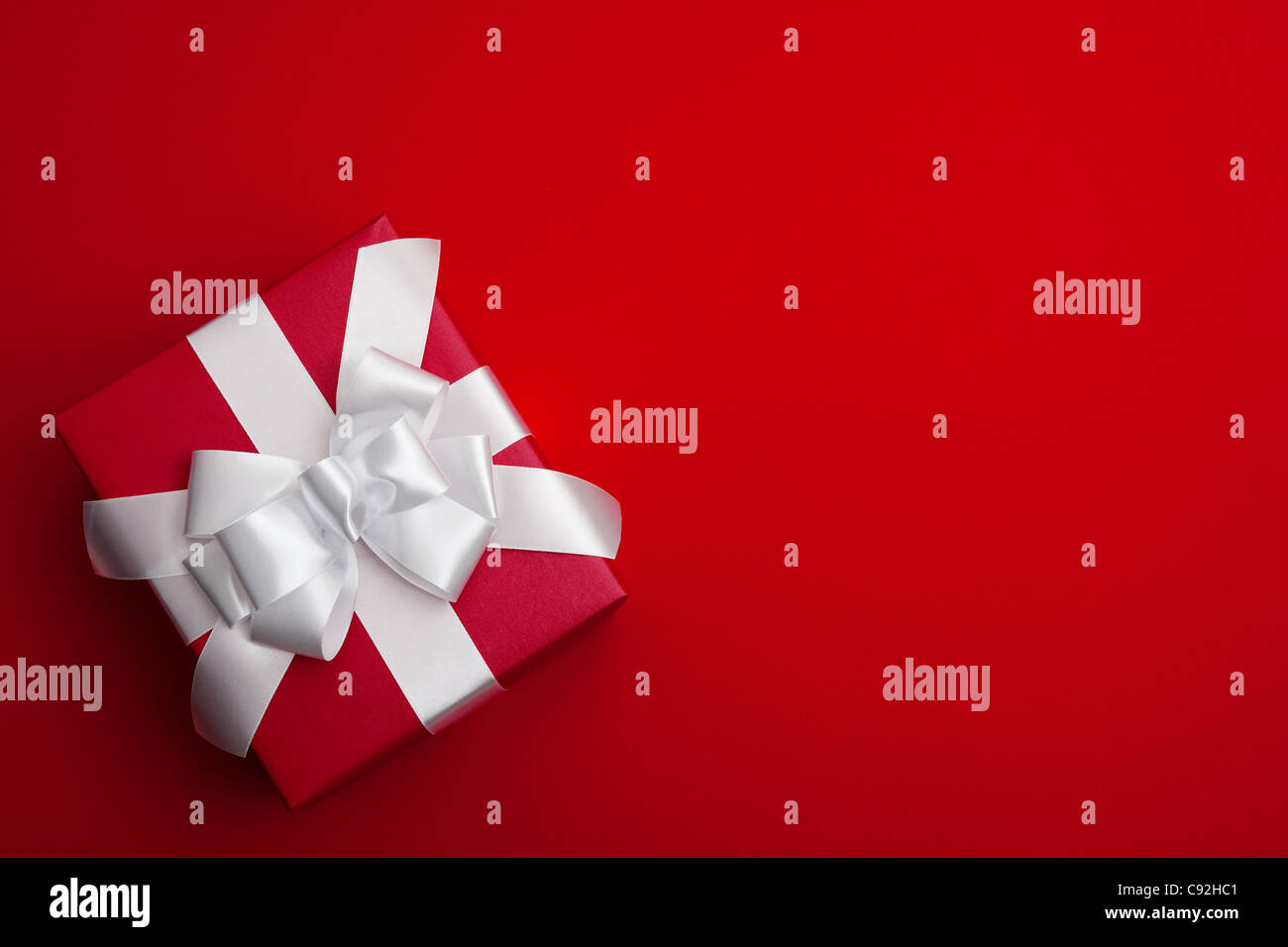 A gift wrapped in red paper Stock Photo Alamy