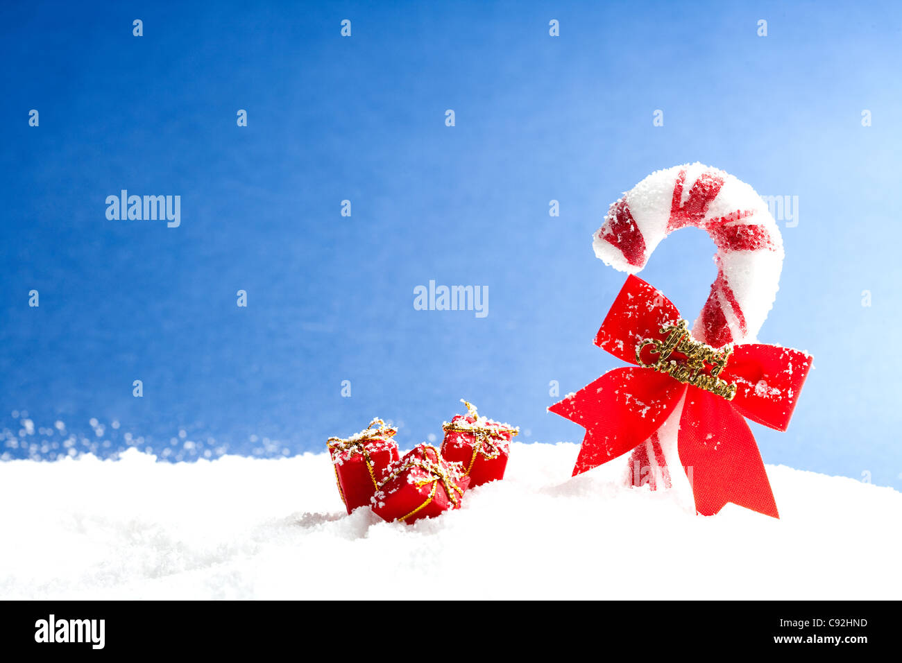 Candy cane with small gift box in winter Stock Photo