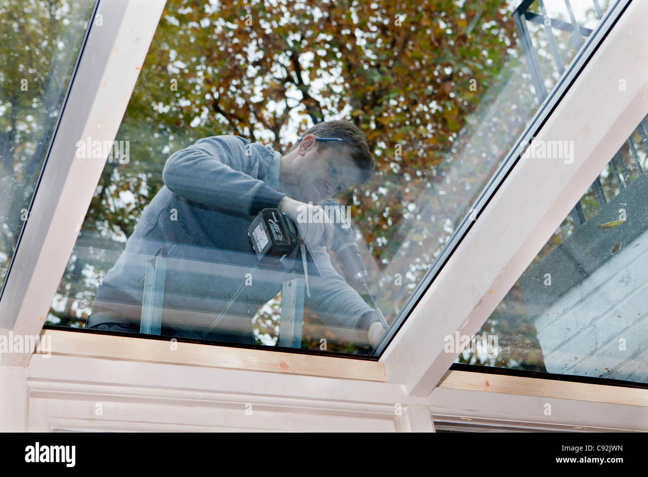 Double-glazing windows being installed on conservatory roof. Stock Photo