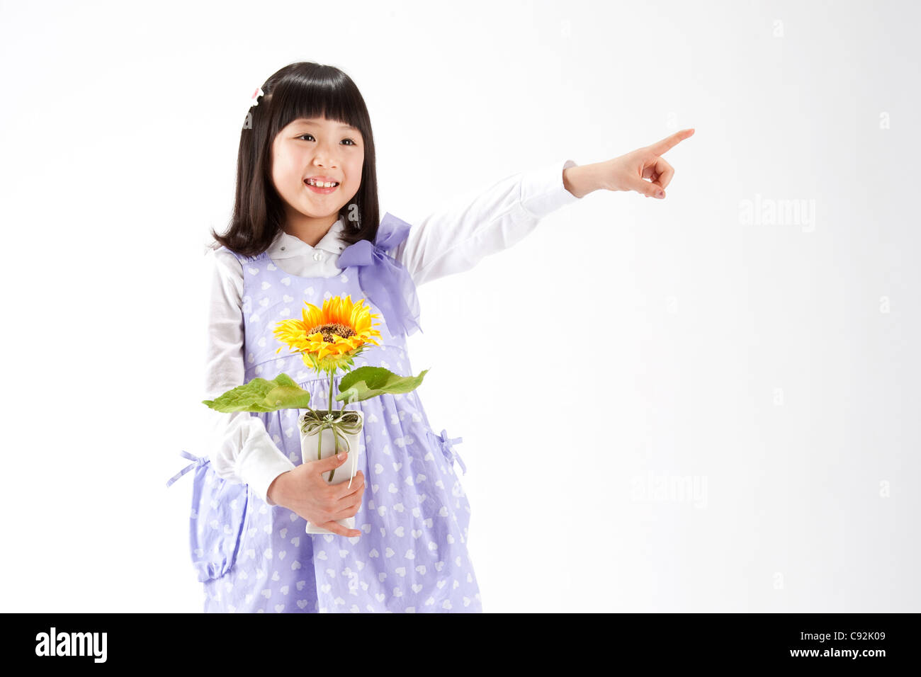 A girl holding potted flower plant, portrait Stock Photo - Alamy