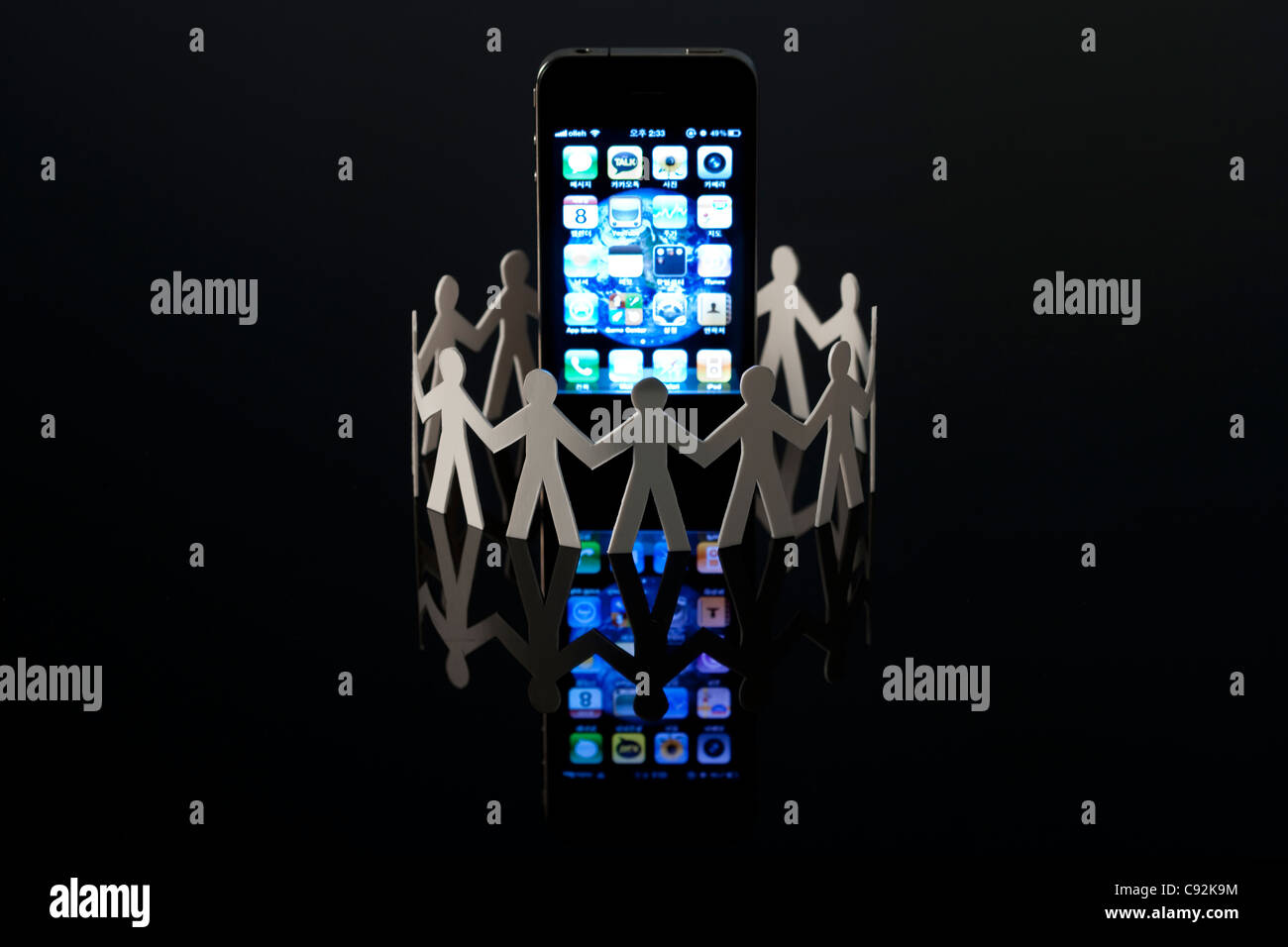 Miniature of human surrounding smart phone Stock Photo - Alamy
