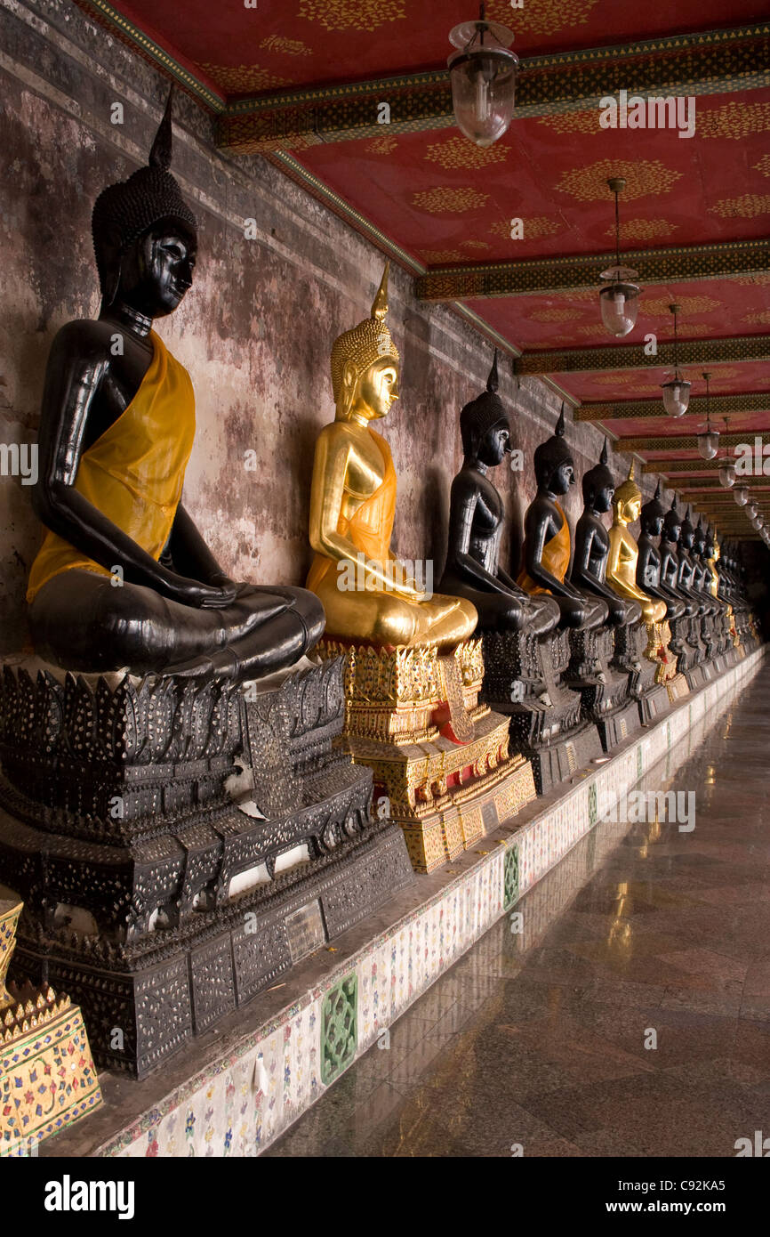 Black and gold Buddha statues sitting in a row, Bangkok, Thailand. Stock Photo