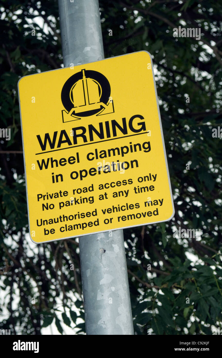 Car wheel clamp warning sign in a private road Stock Photo Alamy