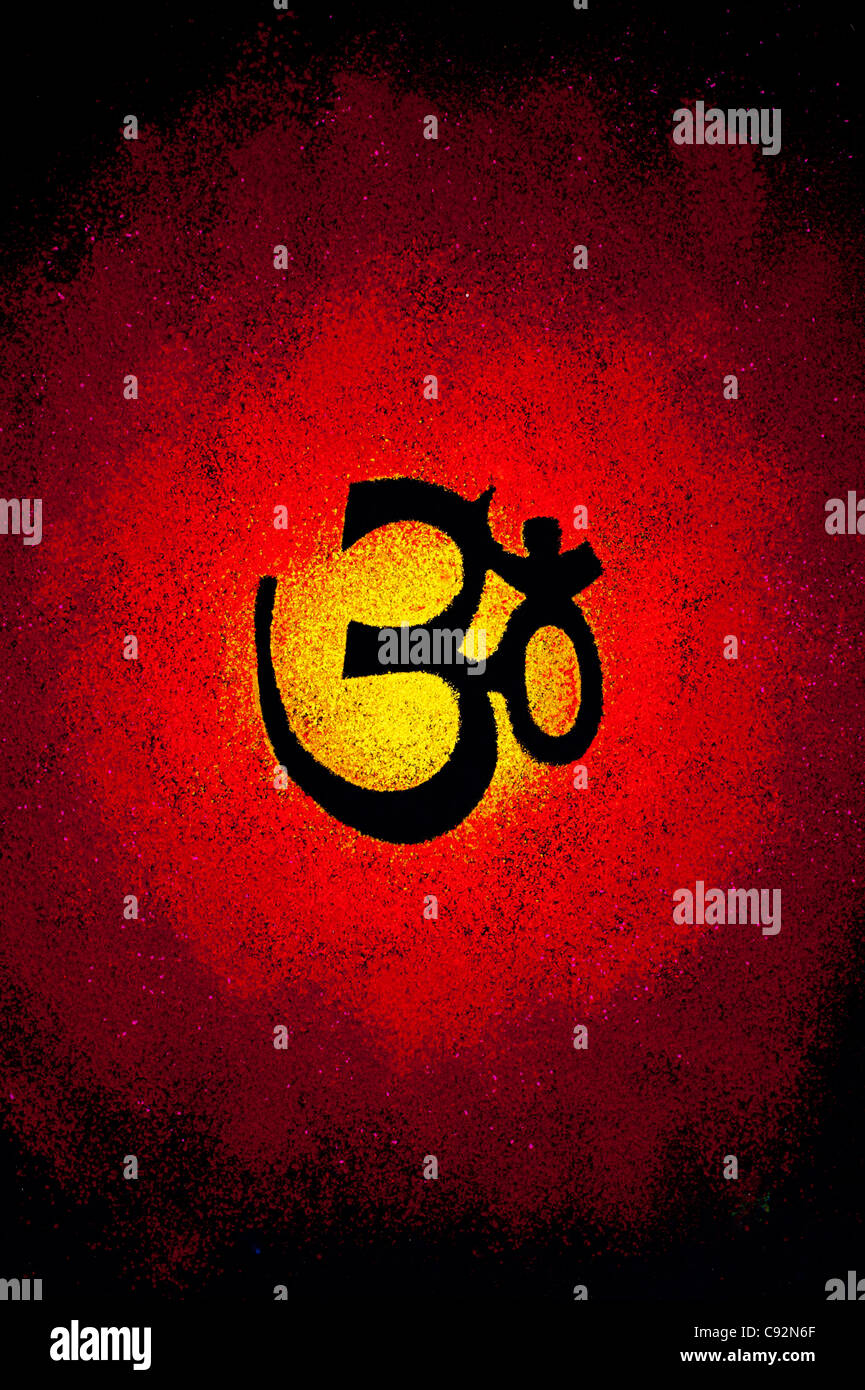 Hindu OM / AUM symbol on coloured powder on black Stock Photo