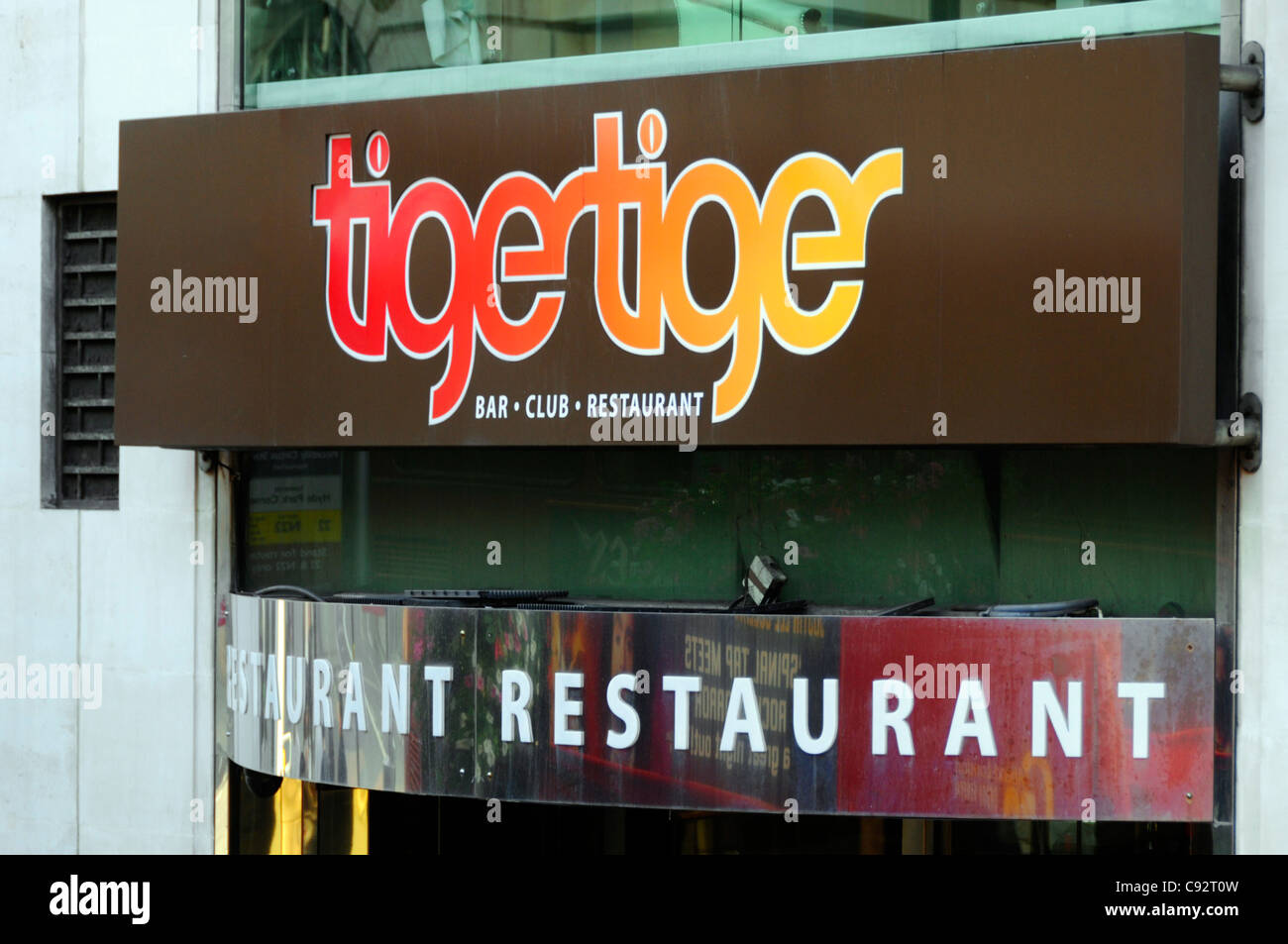 Exterior sign above entrance for the Tiger Tiger nightclub or night club restaurant bar complex in Haymarket London West End England UK Stock Photo