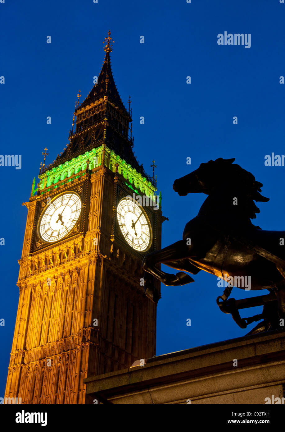 Horse statue part of Boadicea and chariot and Big Ben Clock Tower of Houses of Parliament at night London England UK Stock Photo
