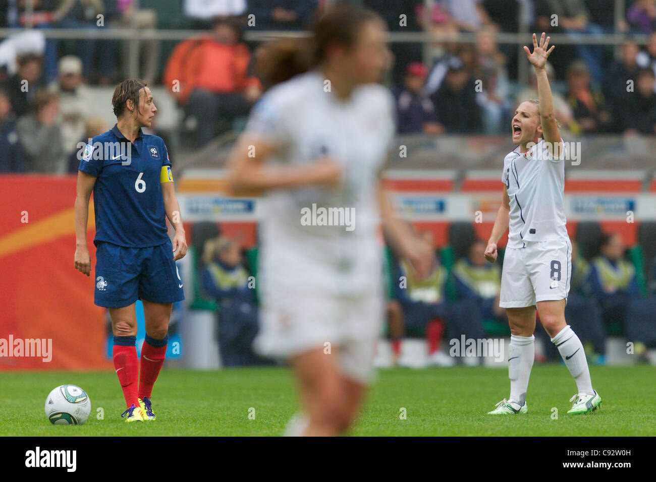 Amy Rodriguez of the USA (R) gestures as France team captain Sandrine Soubeyrand (L) looks on during a 2011 World Cup match. Stock Photo
