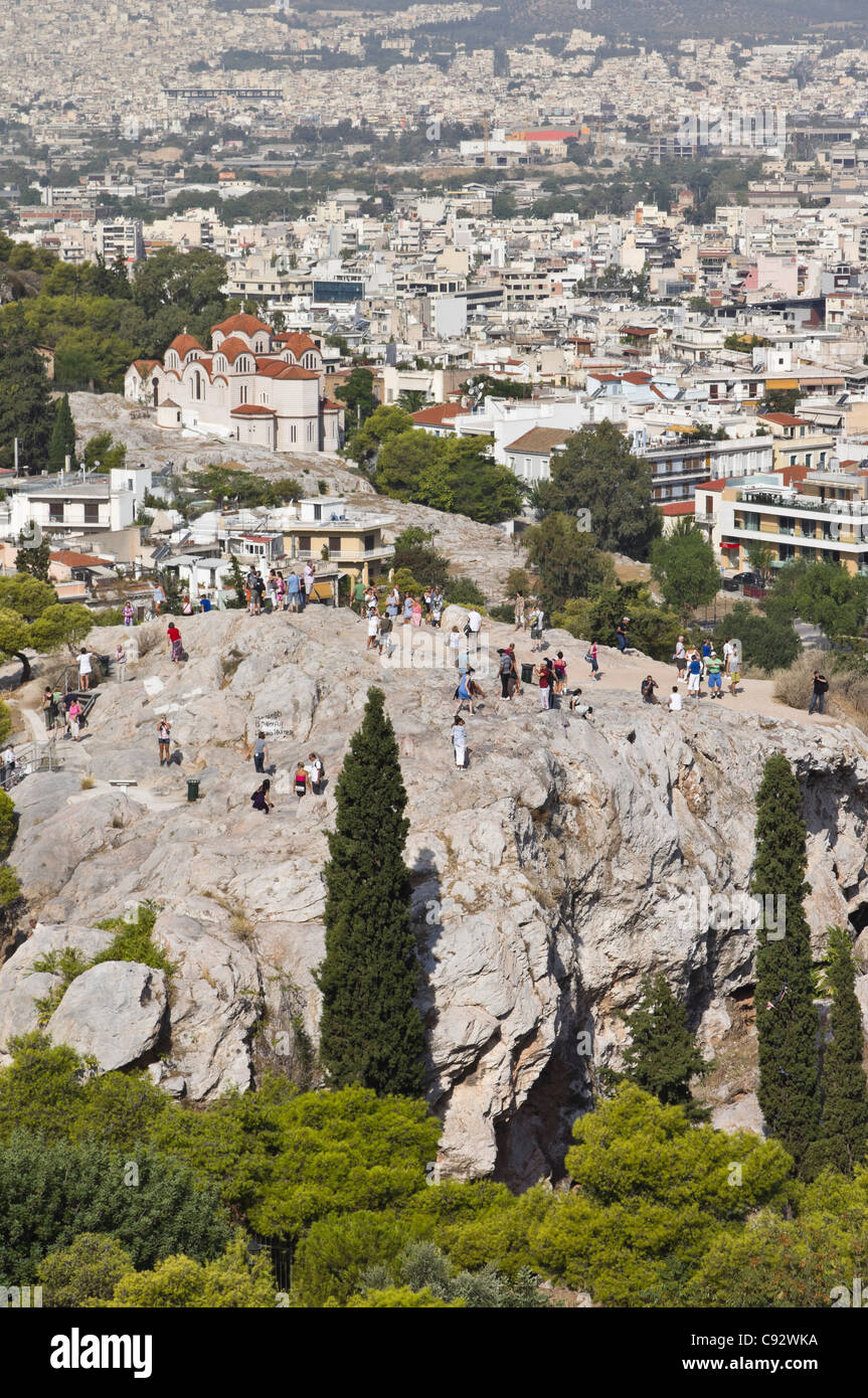 Athens - tourists clamber around on the rock of Mars Hill, the Areopagus. Stock Photo