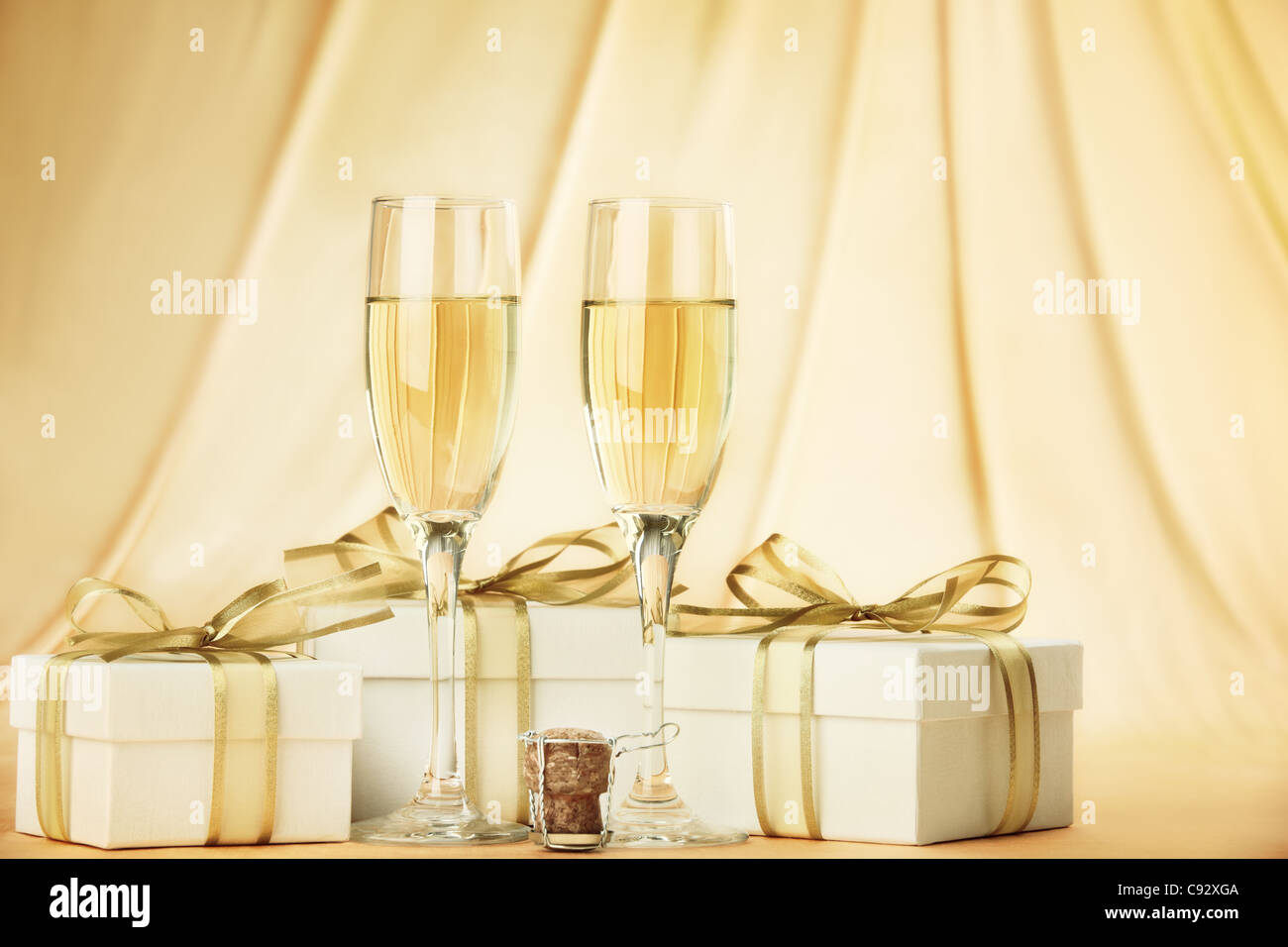 Glasses of champagne with gift boxes Stock Photo