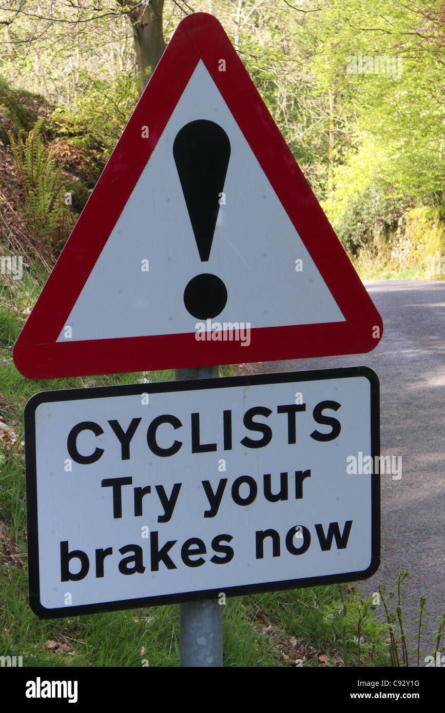 A road sign in the Lake District warning cyclists to try their brakes before a steep descent Stock Photo