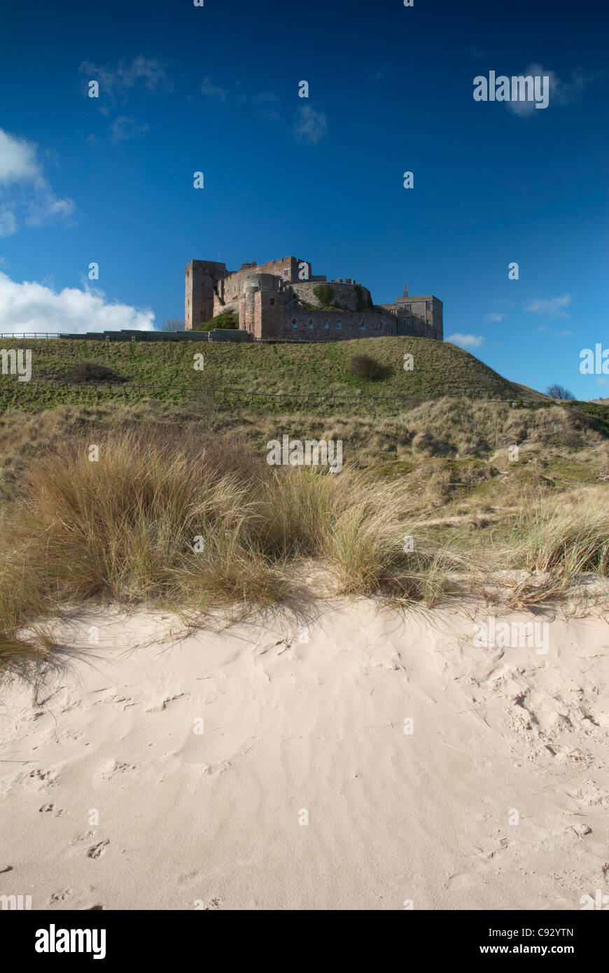 Bamburgh Castle is on a basalt rock outcrop on the coast of Northumberland. Stock Photo