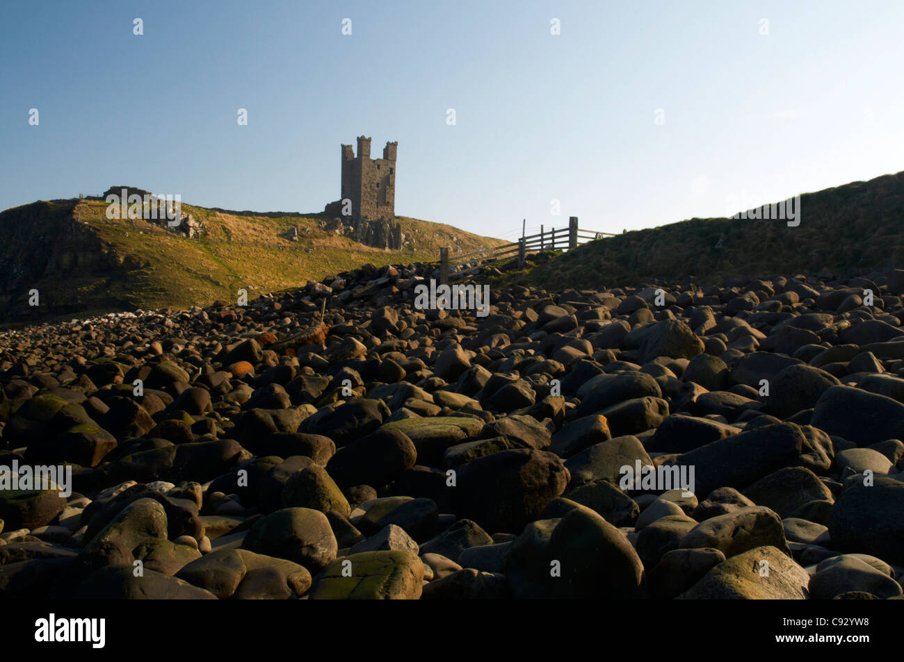 Dunstanburgh Castle is a historic ruin on a headland, founded in the ...