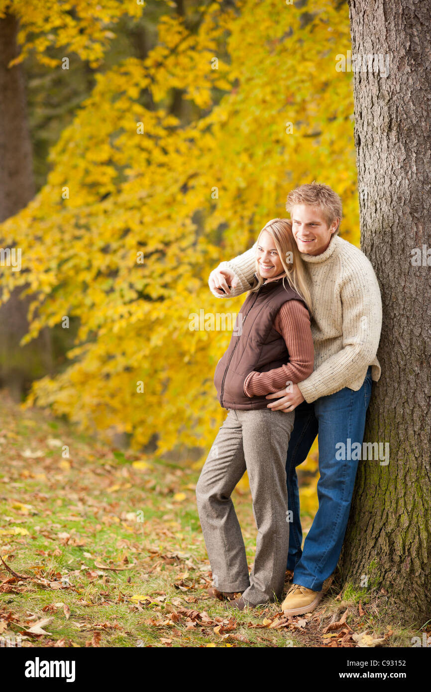 Autumn romantic couple happy together hugging in park pointing Stock ...