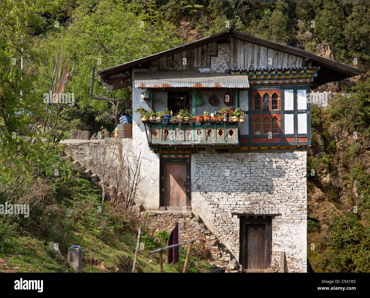 A Traditional Stone Bhutanese House Built On A Hillside Stock Photo Alamy a-traditional-stone-bhutanese-house-built-on-a-hillside-stock-photo-alamy